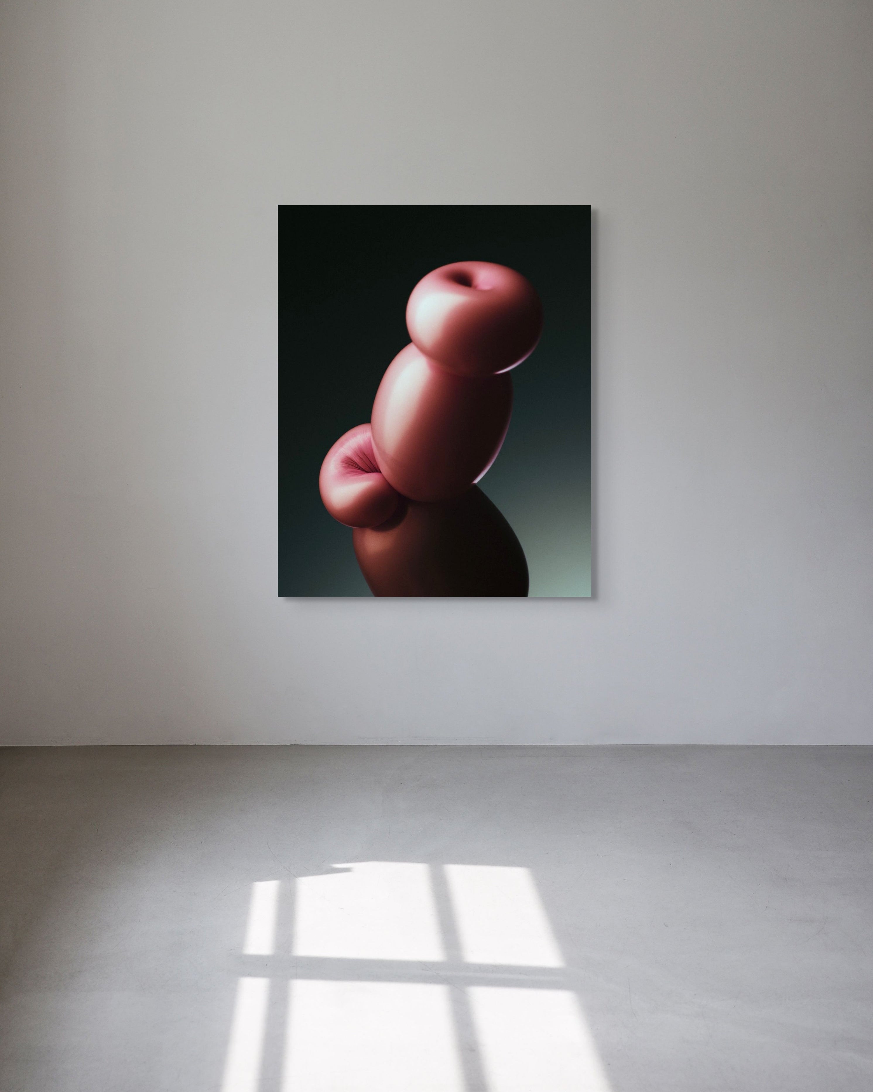 Abstract metal print of pink and red shapes on a black background, displayed on a white wall.