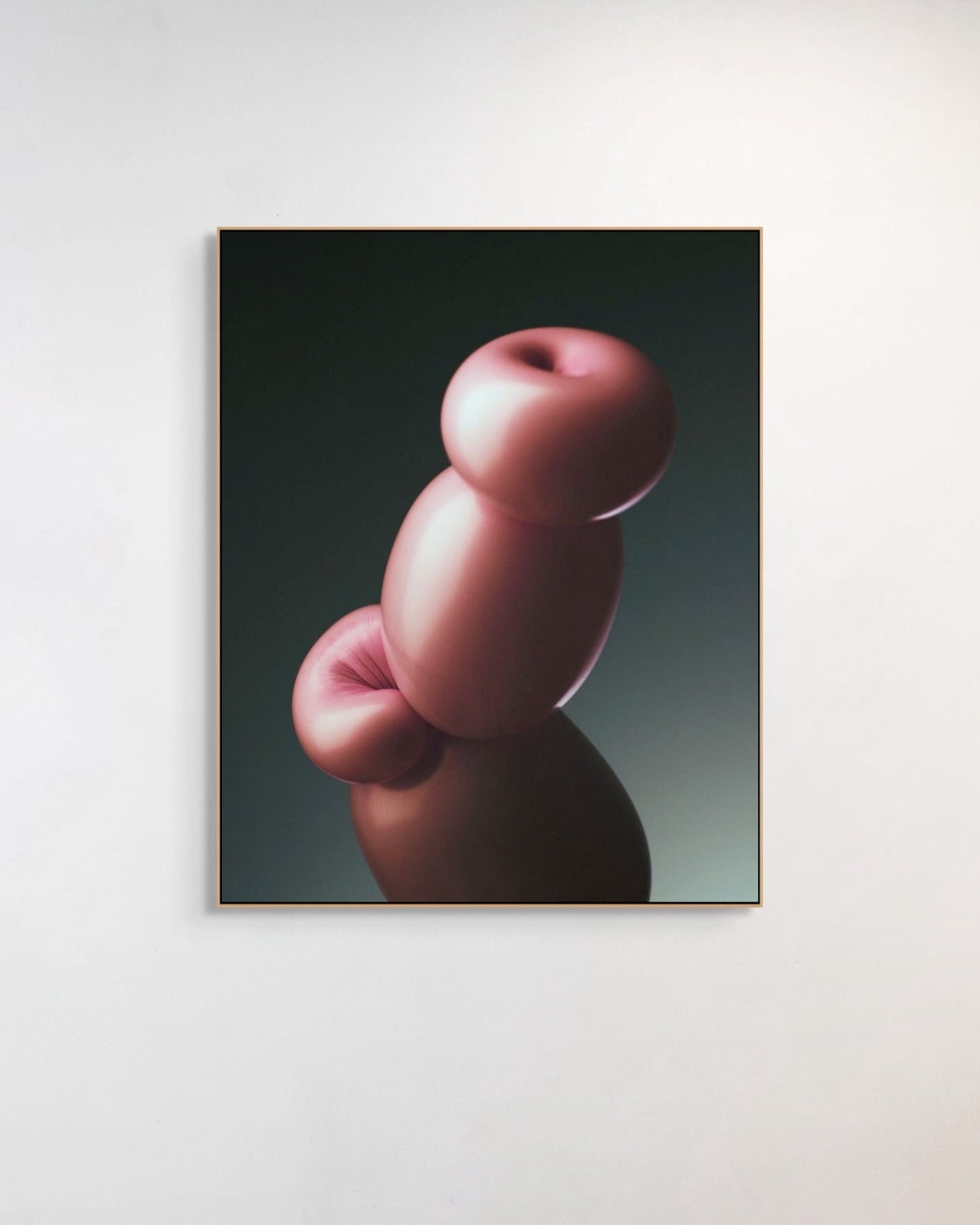 Framed artwork of abstract pink shapes on a dark background