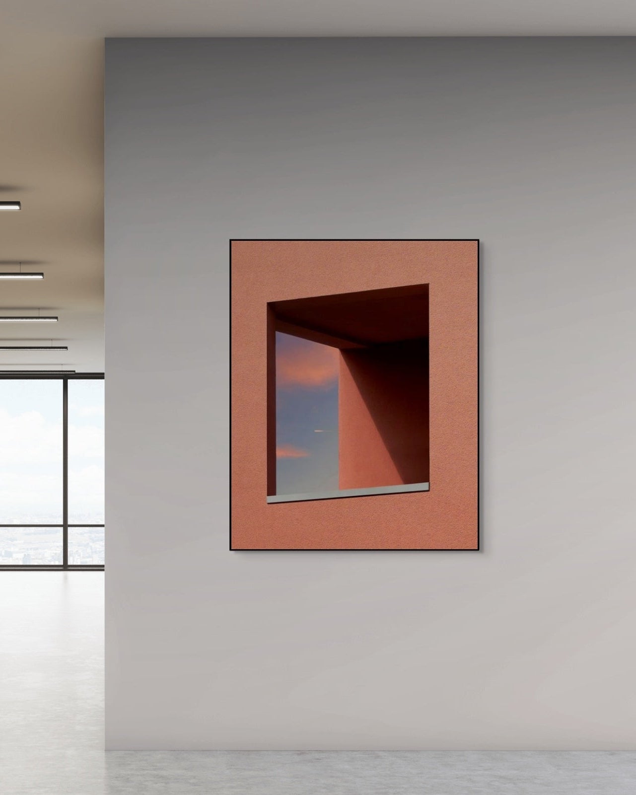 Metal print on a gray wall with a window in the background