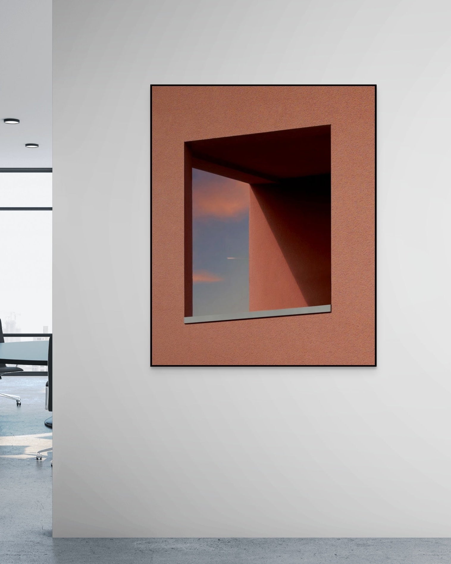 Abstract metal print with geometric design on a white wall in an office setting