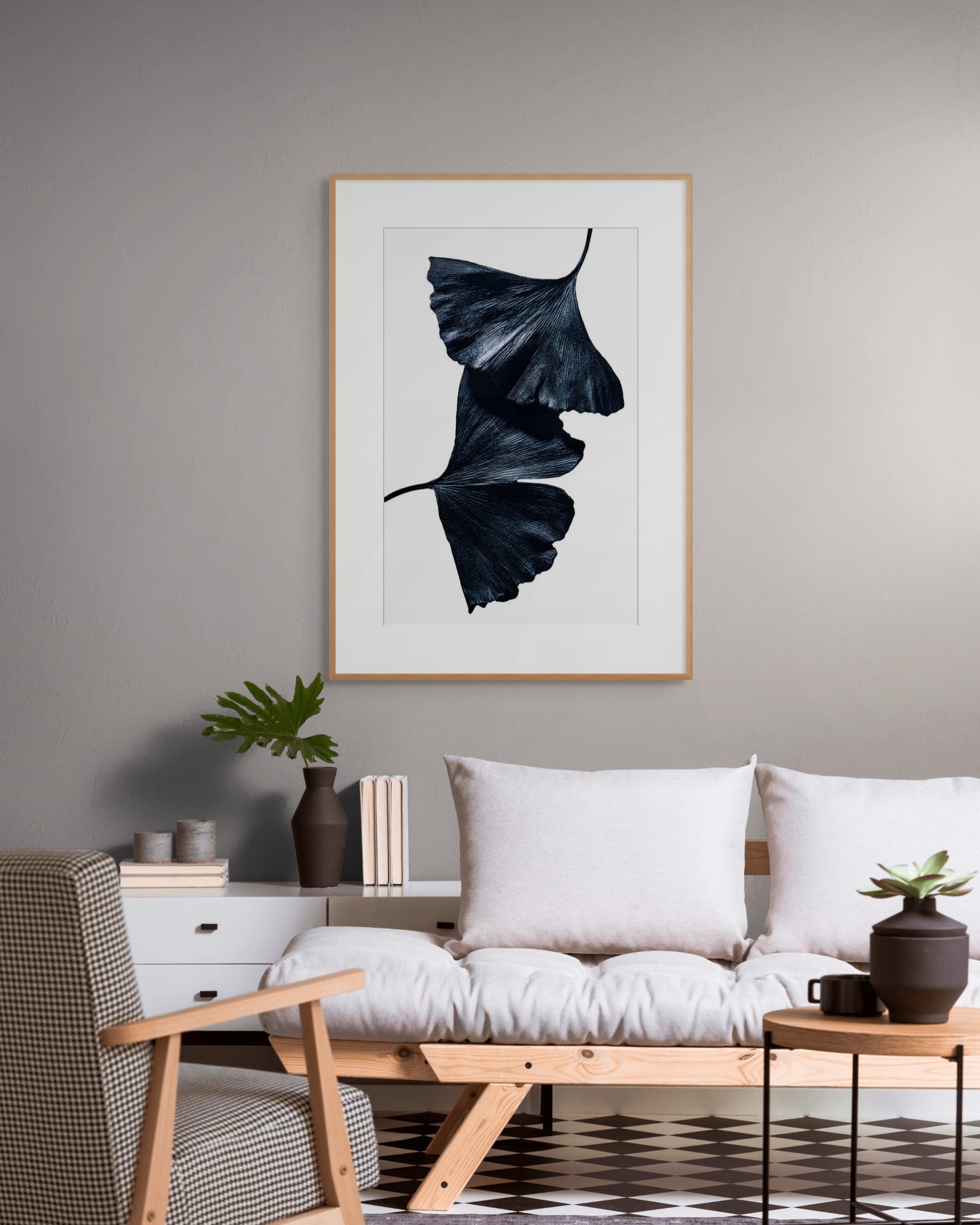 Gingko 2 by Sivan Roshianu – Limited edition black and white fine art photograph, archival-quality print in a modern living room with a sofa, chair, and framed leaf art on a gray wall.