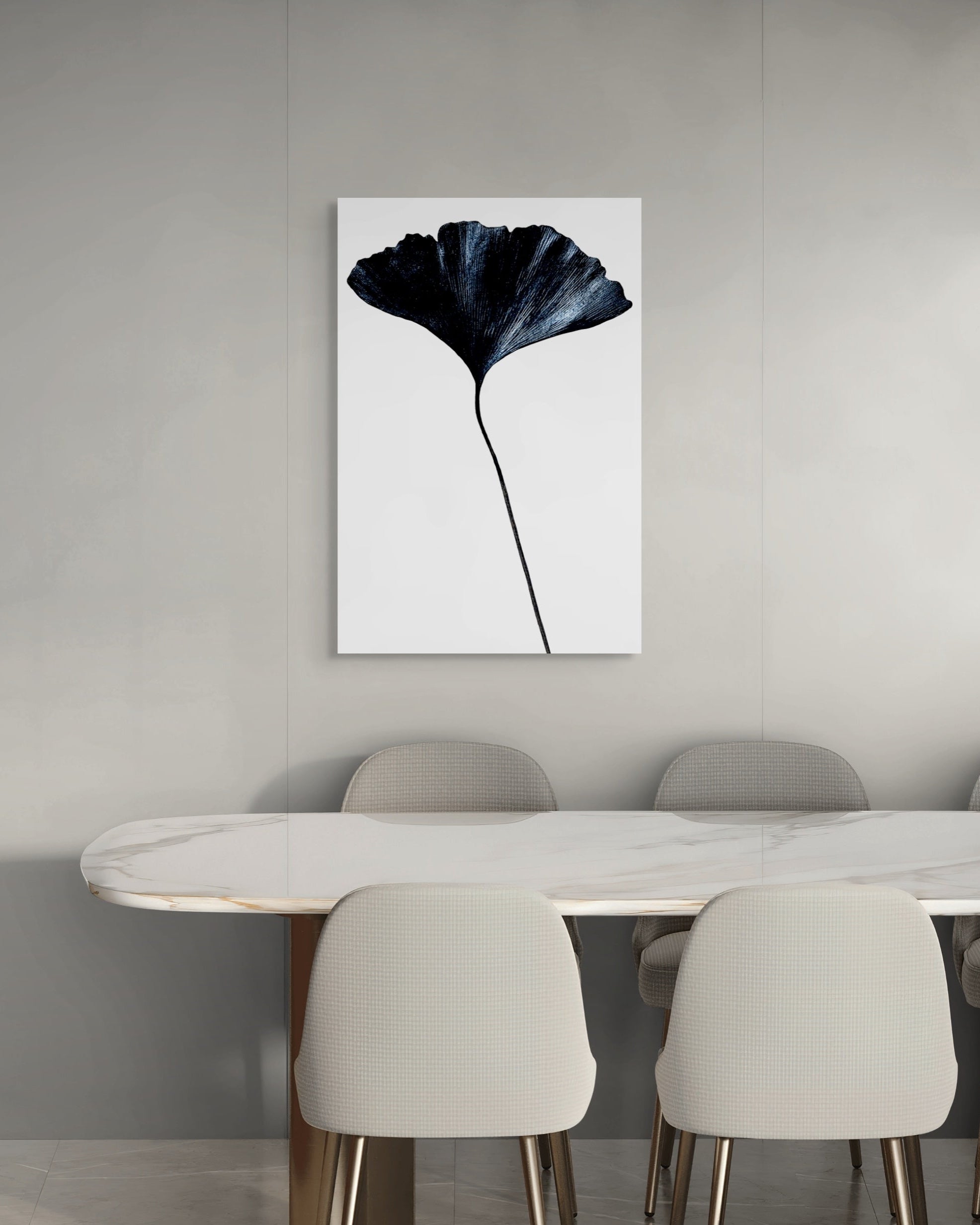 Dining room with a large abstract metal print of a leaf on the wall above a table and chairs.