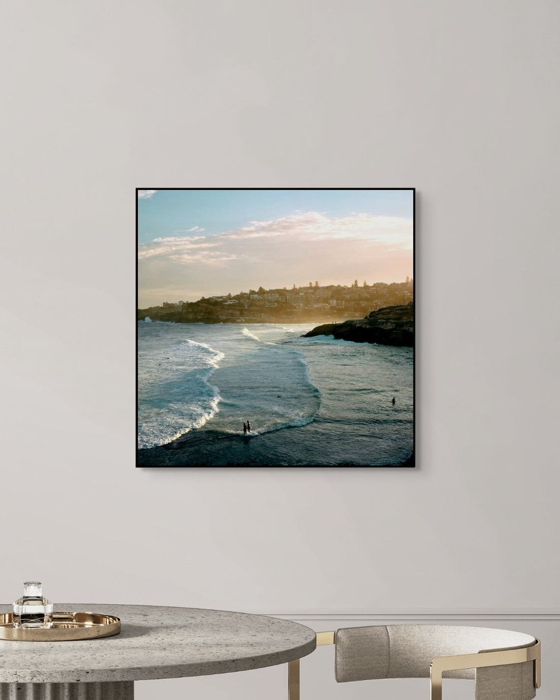 Framed artwork of a coastal scene on a wall in a modern interior setting.