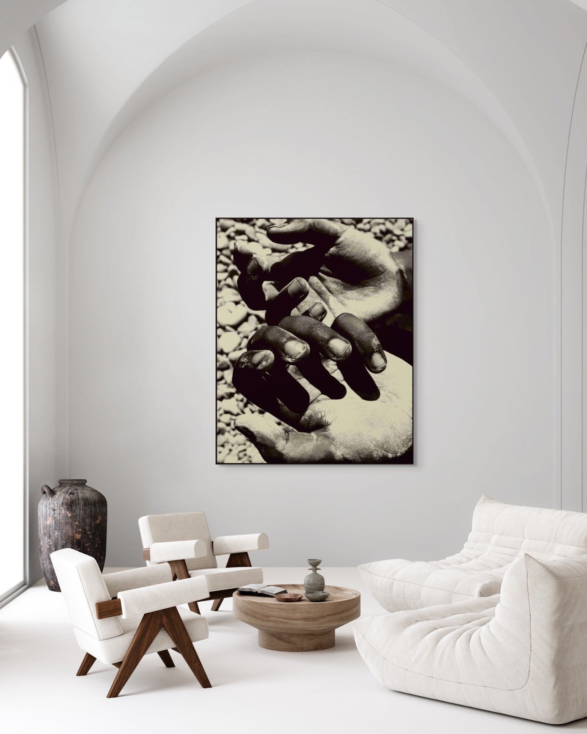 Modern interior with a large abstract black and white painting on a wall, featuring two hands.
