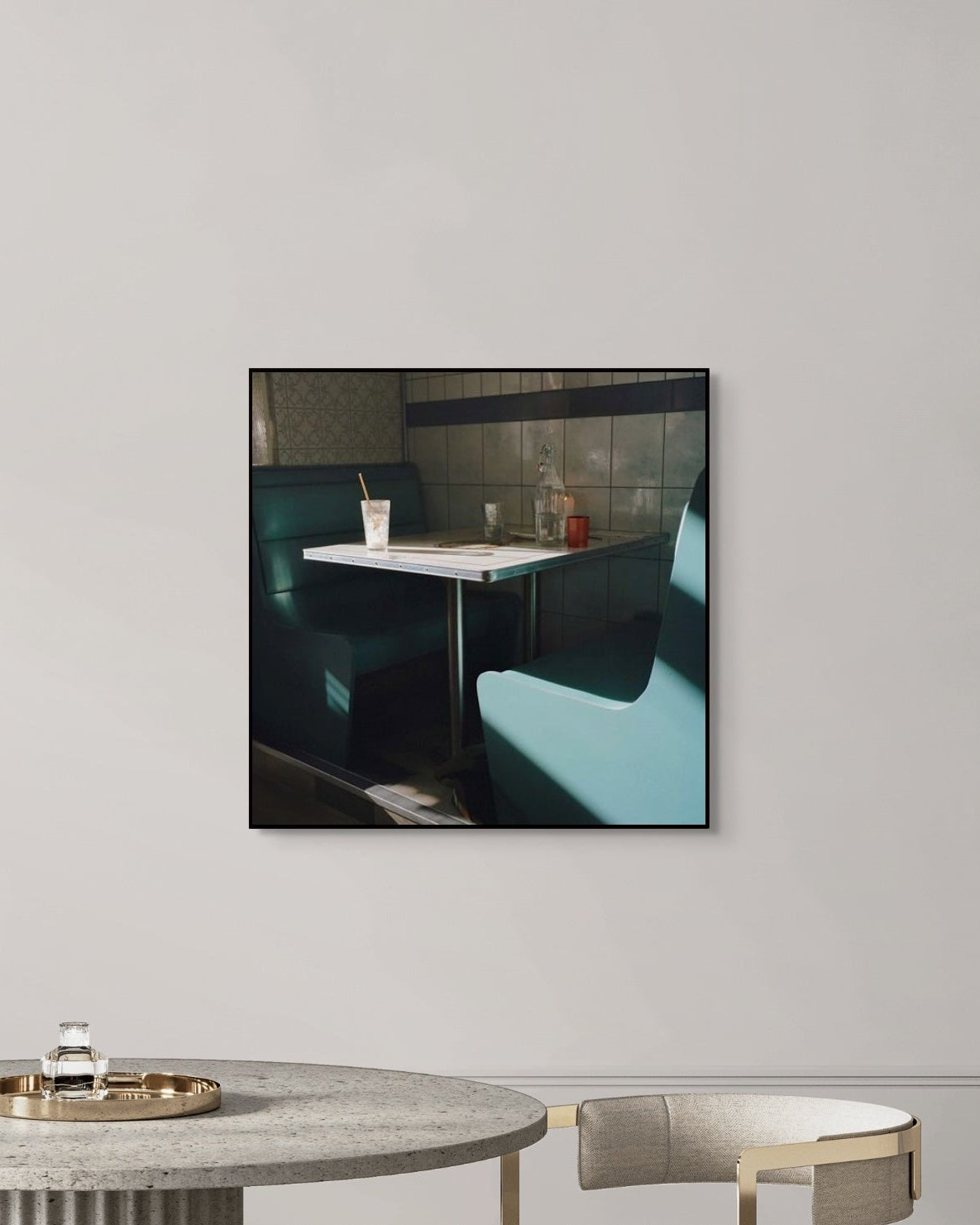 Framed photograph of a restaurant interior on a wall above a table.