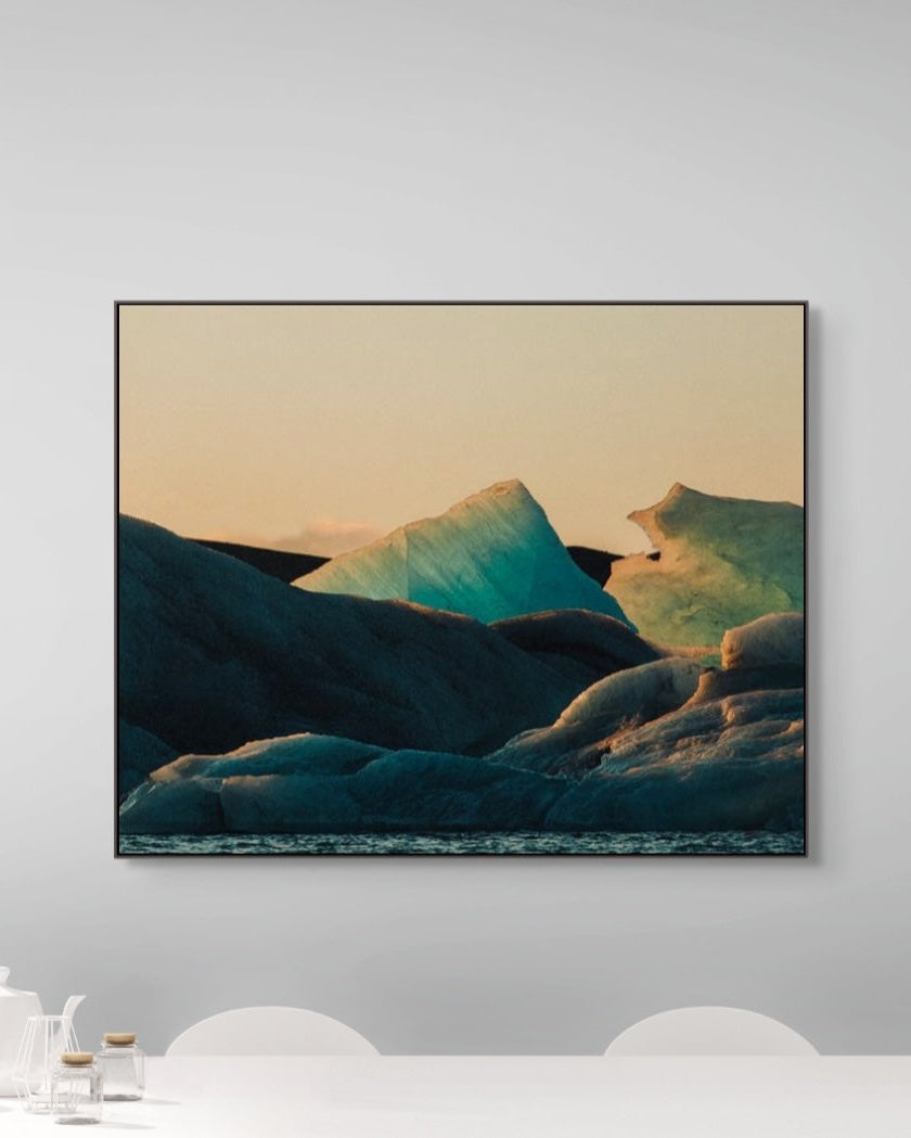 Framed artwork of a mountain landscape on a white wall