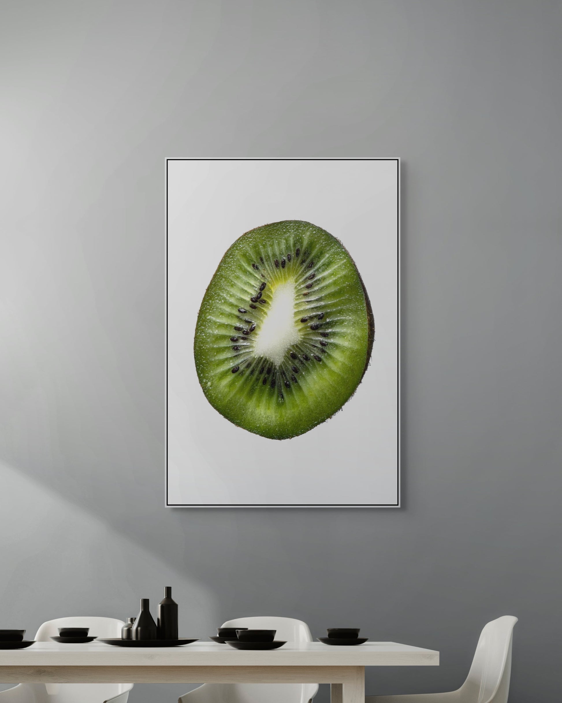 Framed artwork of a sliced kiwi on a gray wall above a dining table.