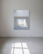 Framed and ready-to hang architectural photograph on a white concrete  wall. 