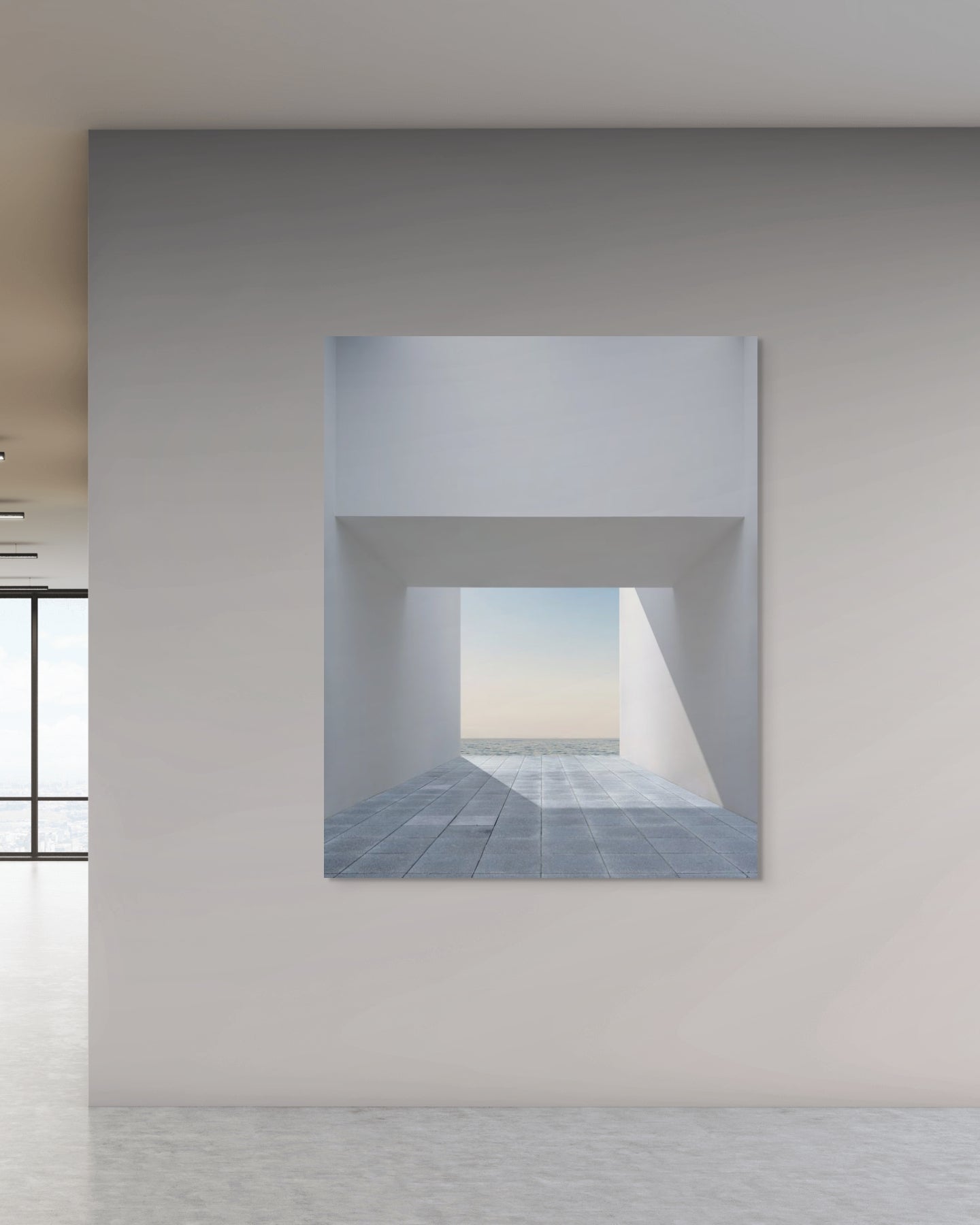Modern interior with large windows and an architectural photograph on a white wall.