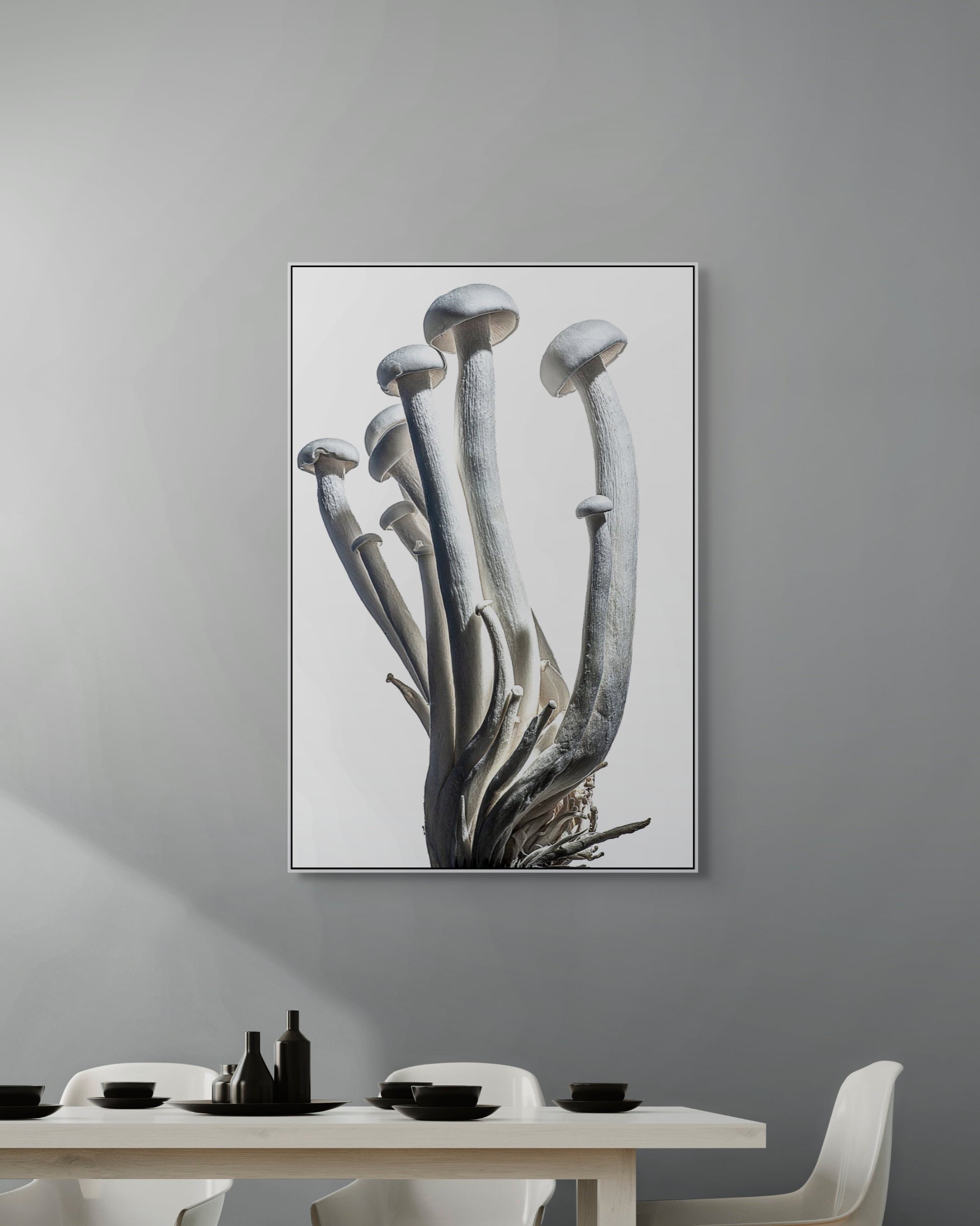 Framed artwork of a mushroom on a gray wall above a dining table.