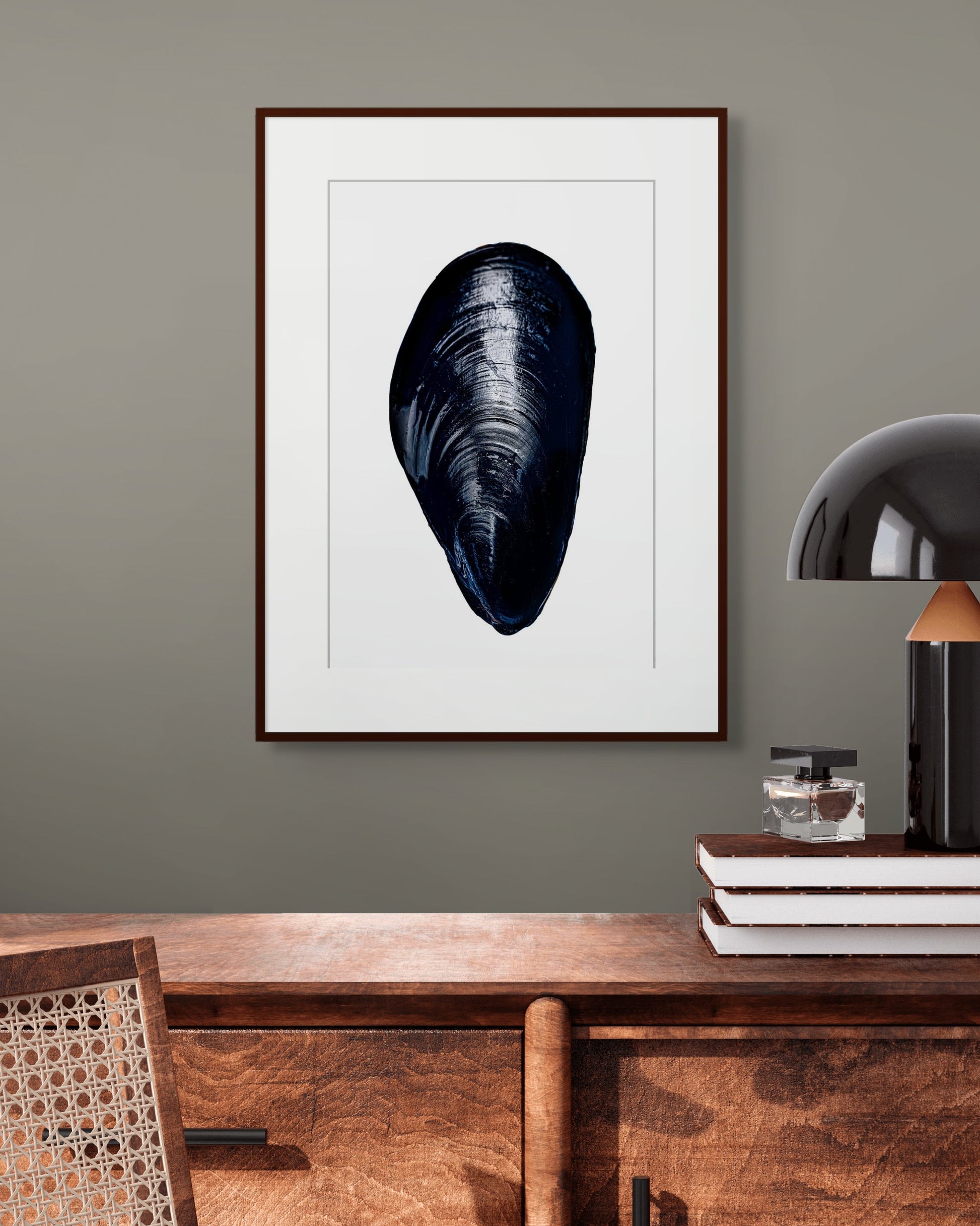 Mussel by Sivan Roshianu – Limited edition black and white fine art photograph, archival print of a shell on a wall above a wooden console table.