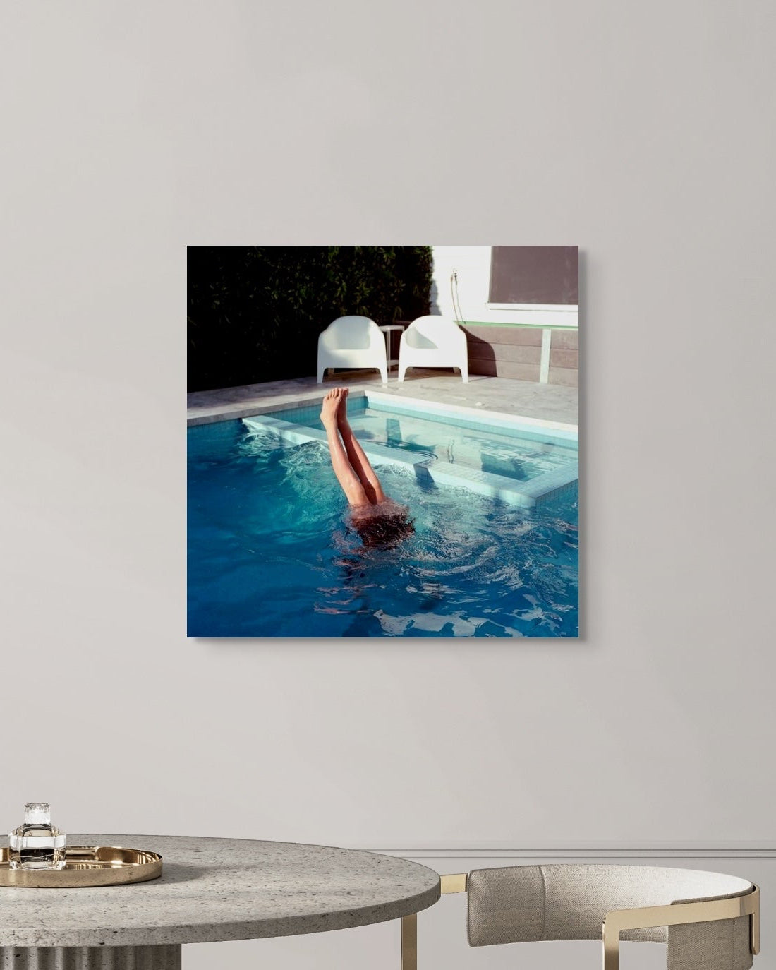 Modern interior with a metal print of a person swimming in a pool on the wall.