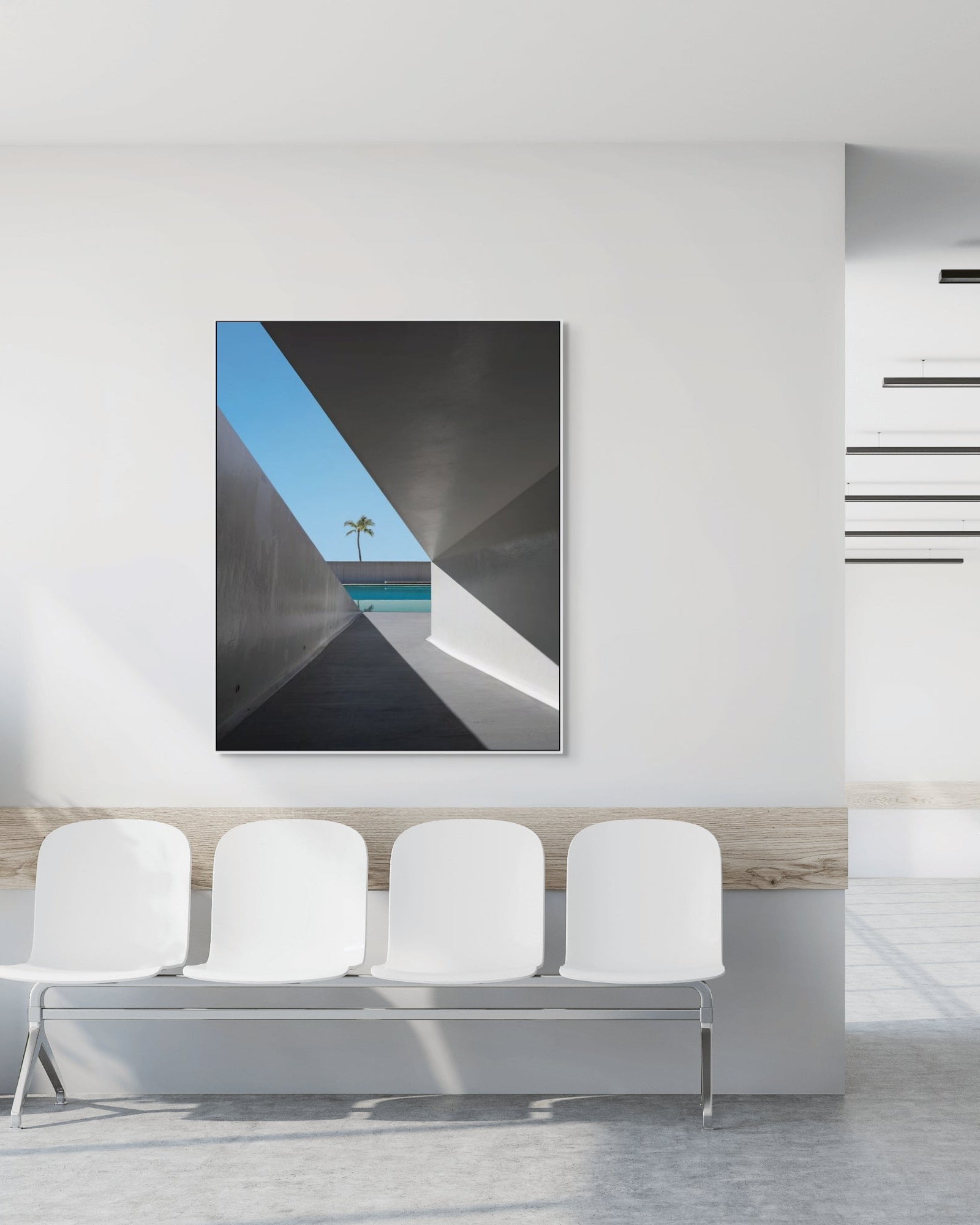 Modern interior with a abstract art on the wall, white chairs, and potted plants.