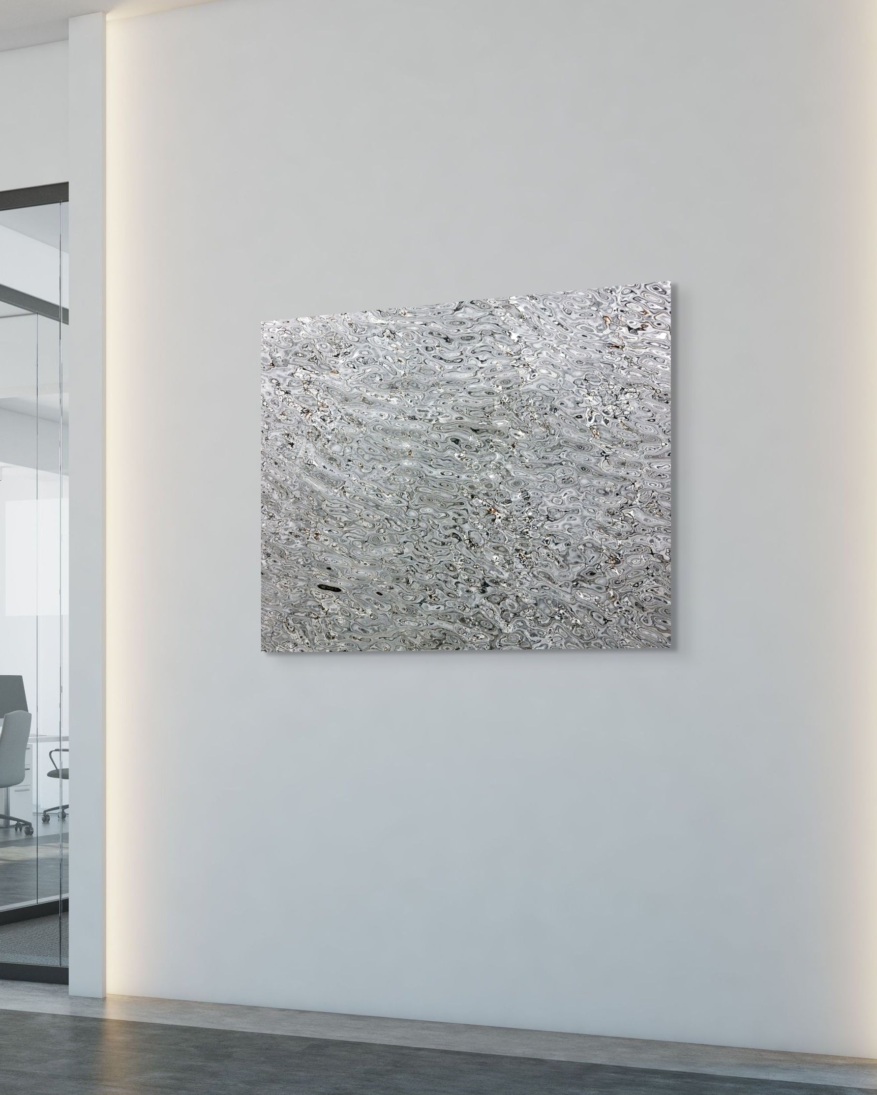 Abstract metal print on a white wall in an office setting