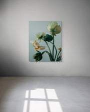 Floral metal print on a white wall with soft lighting