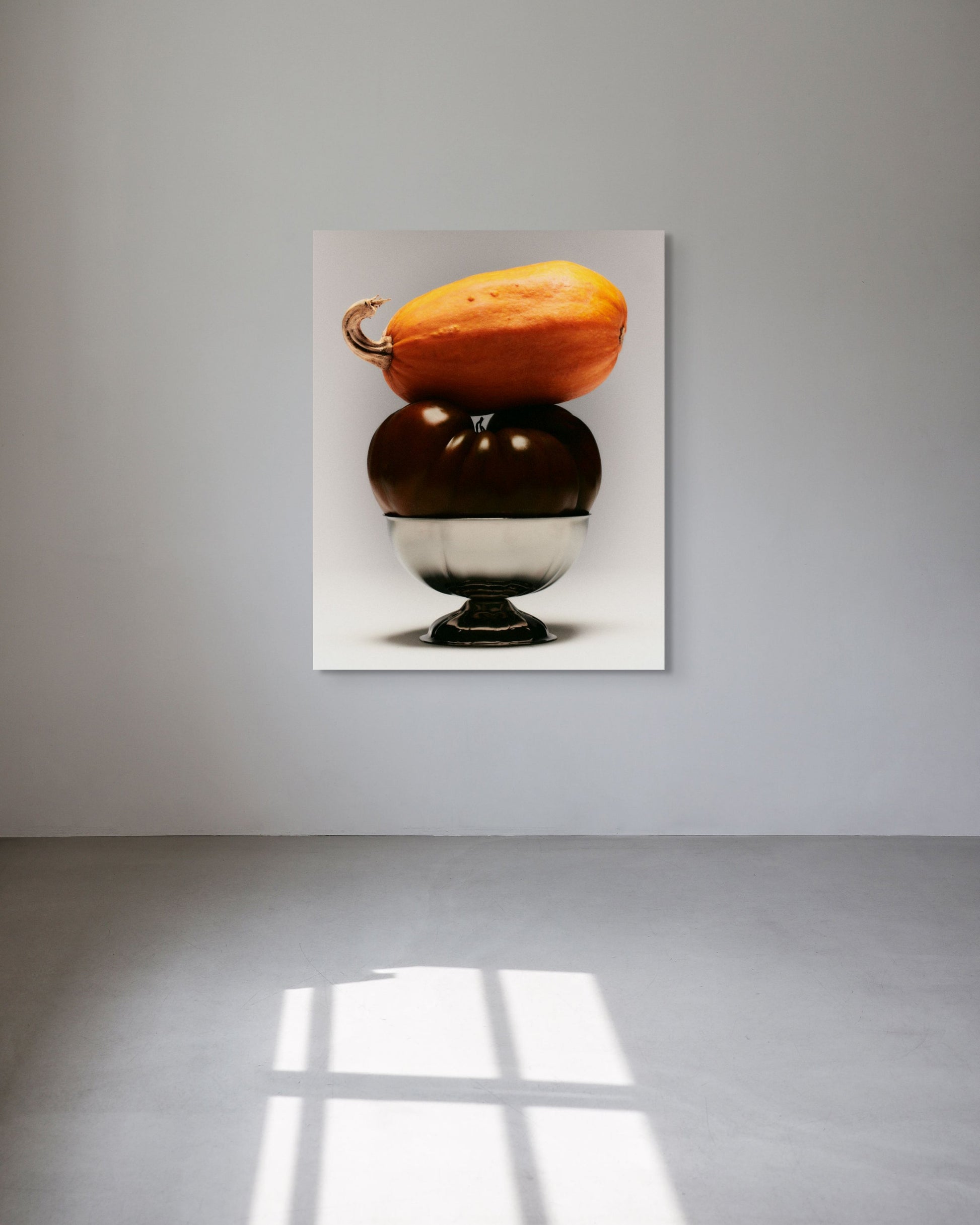 Framed artwork of three stacked pumpkins on a white background