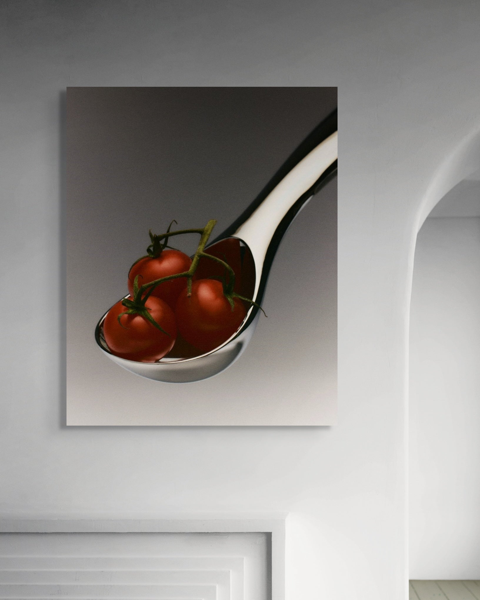 Spoon with tomatoes on a wall in a minimalistic room