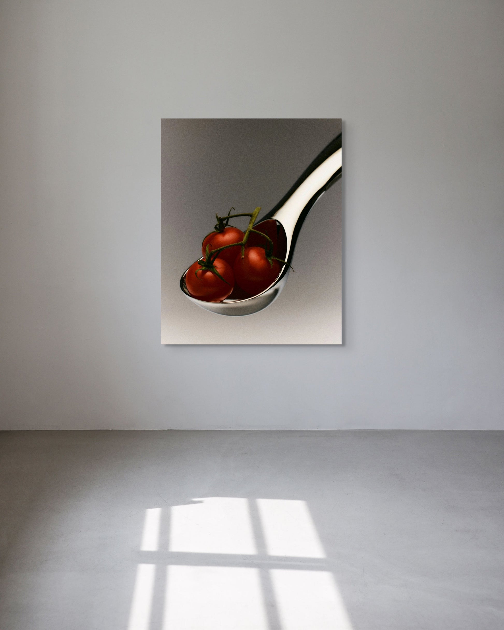 Metal print of a spoon with tomatoes on a reflective surface