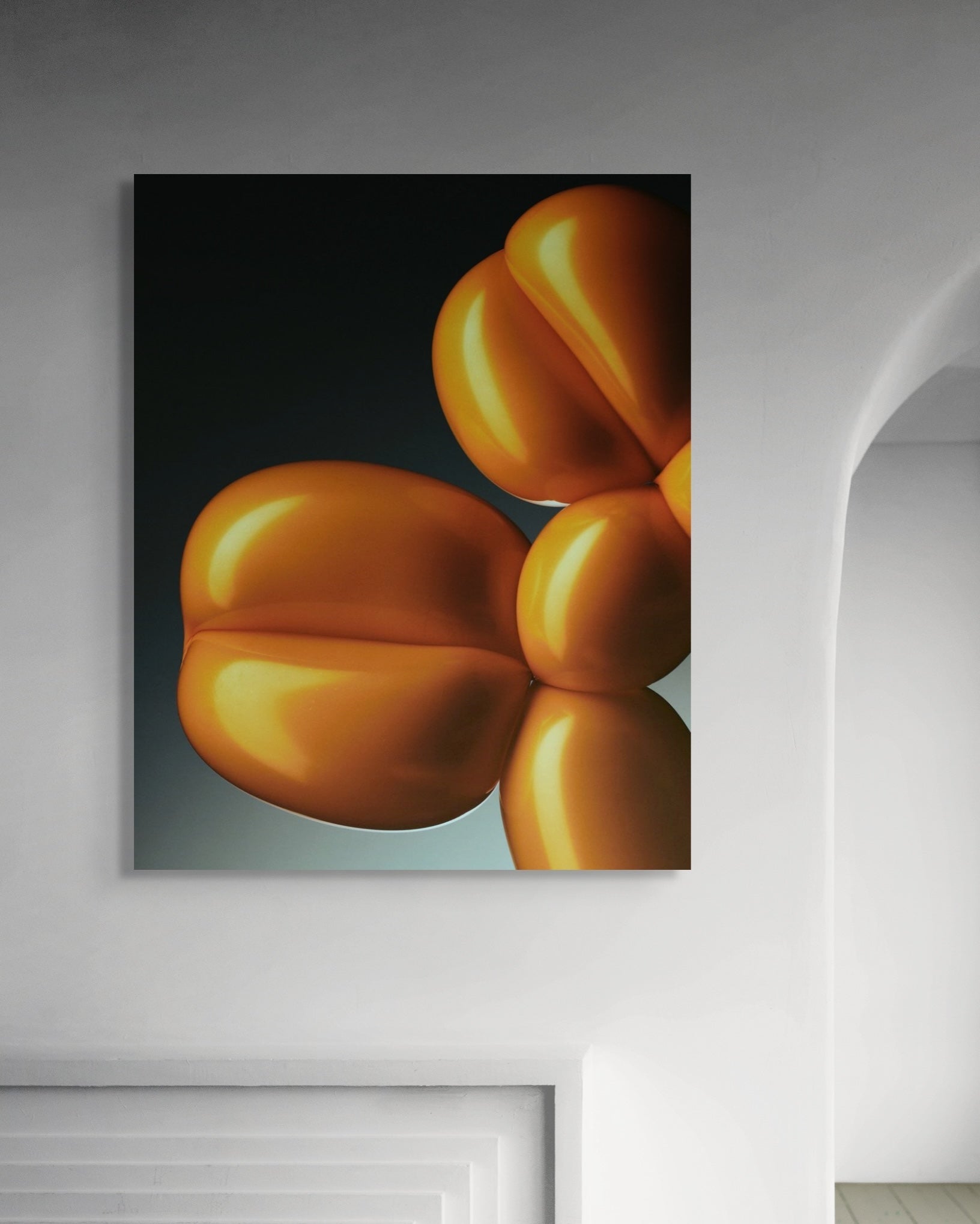 Abstract art piece of orange shapes on a dark background in a modern room.