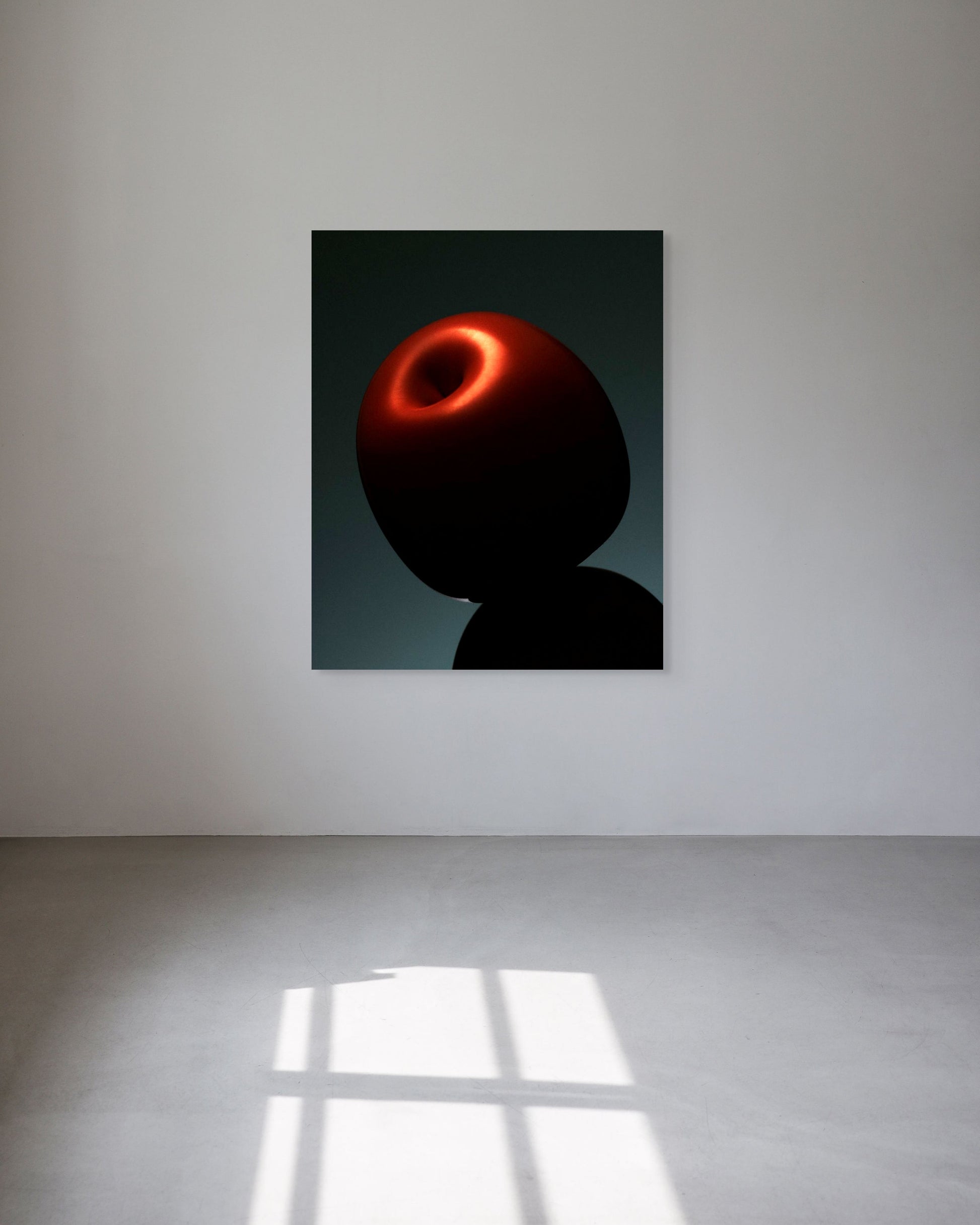 Abstract artwork of a red and black figure on a white wall
