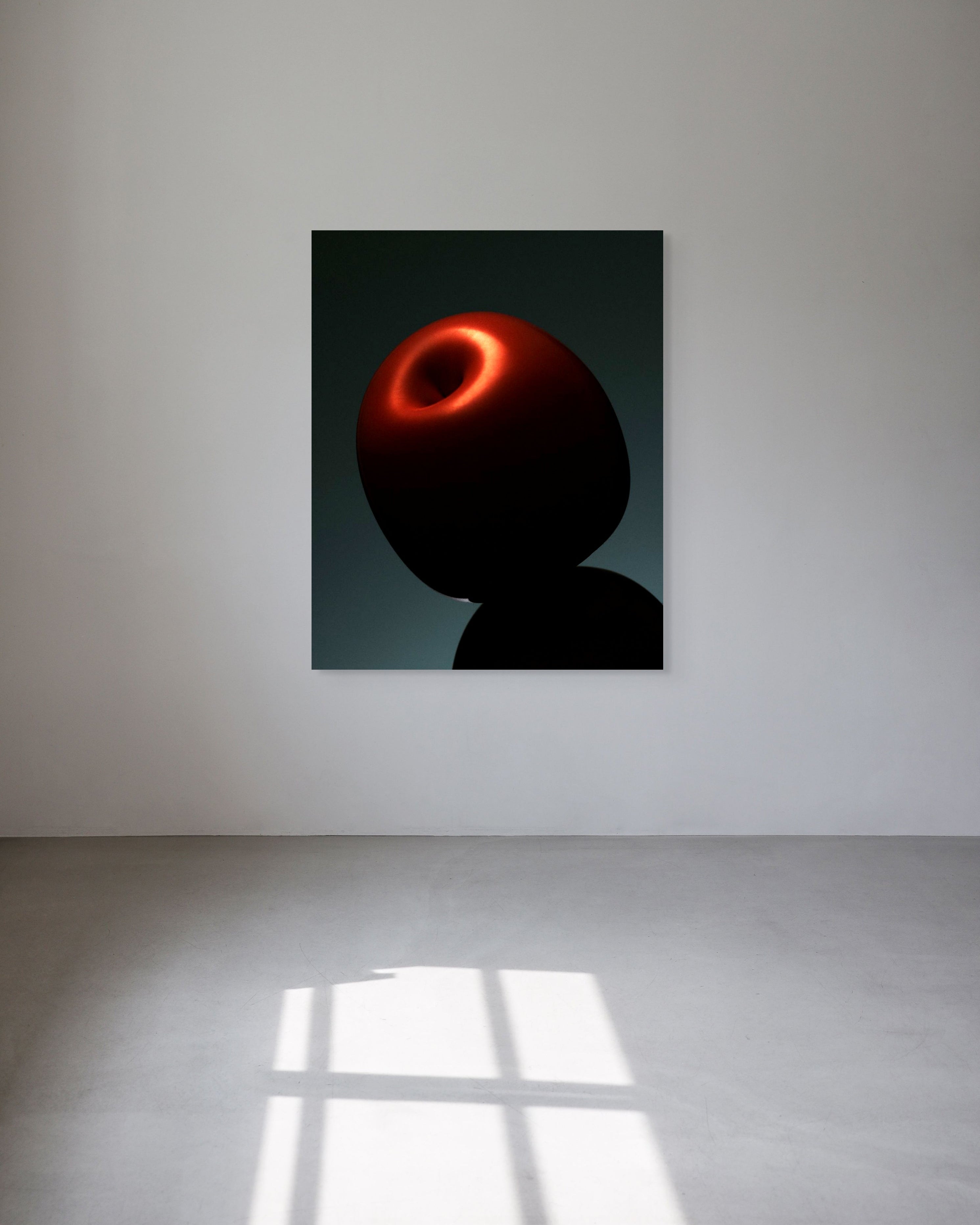 Abstract artwork of a red and black figure on a white wall