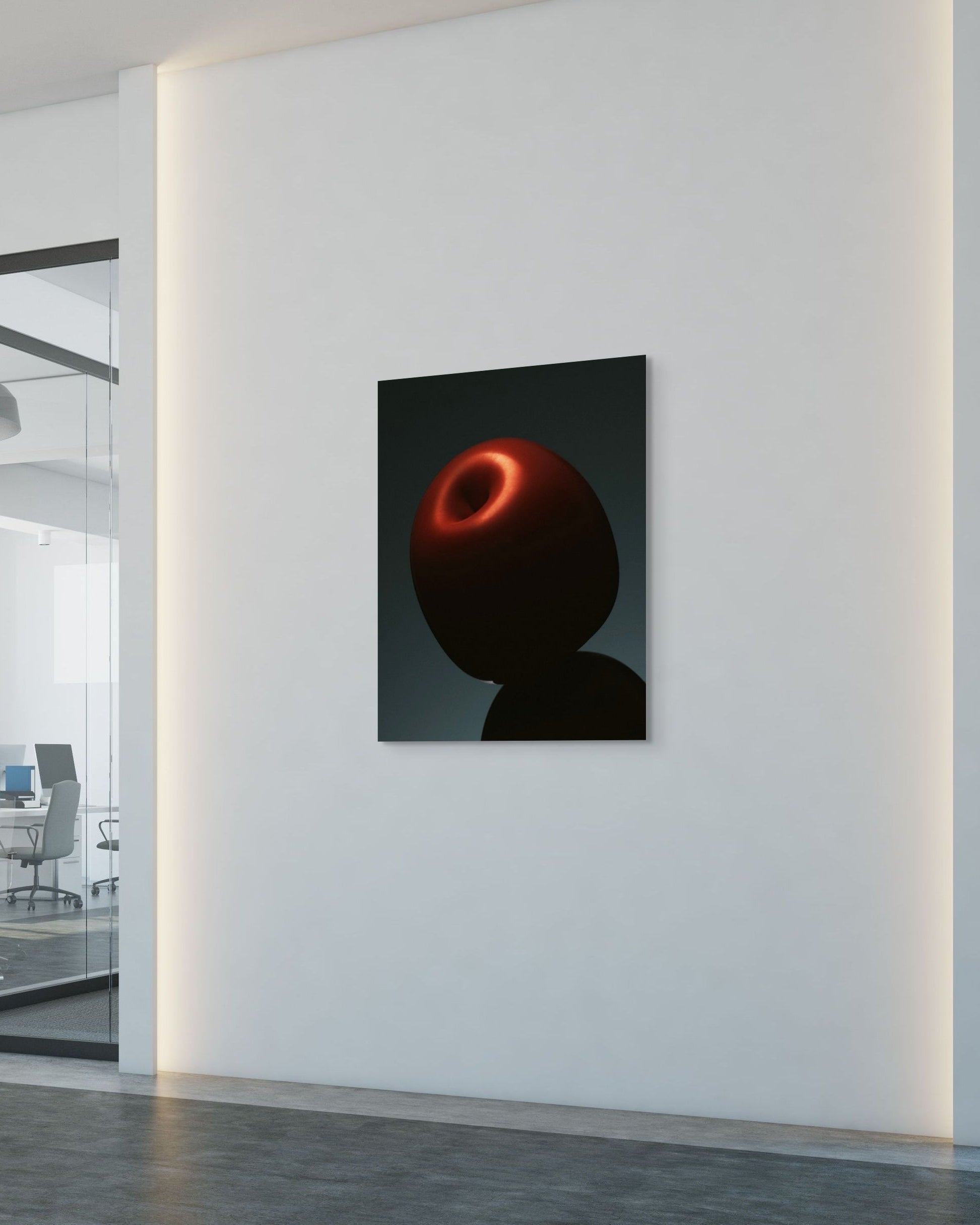 Modern office interior with an abstract artwork on a white wall.
