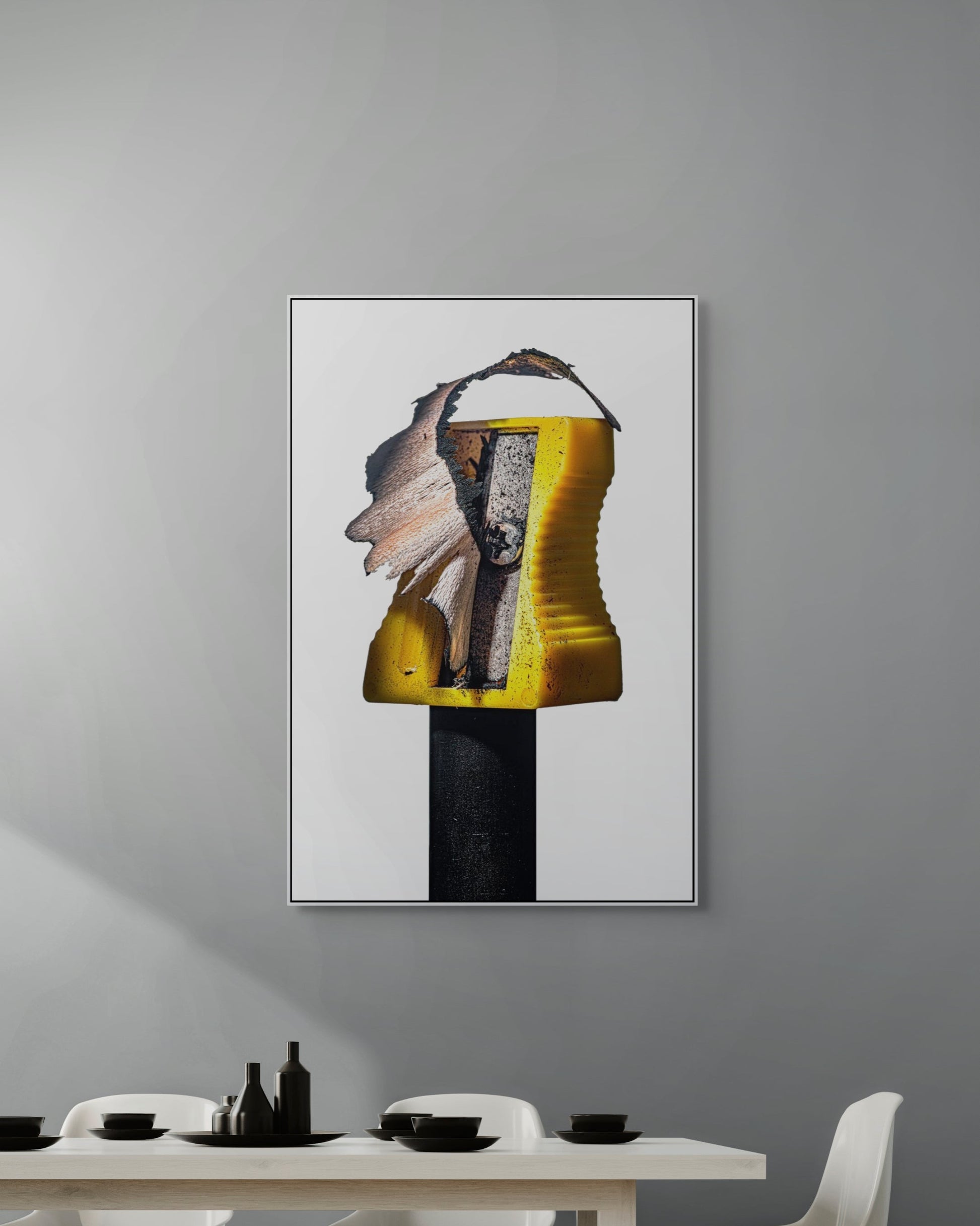 Abstract art piece on a gray wall above a dining table.