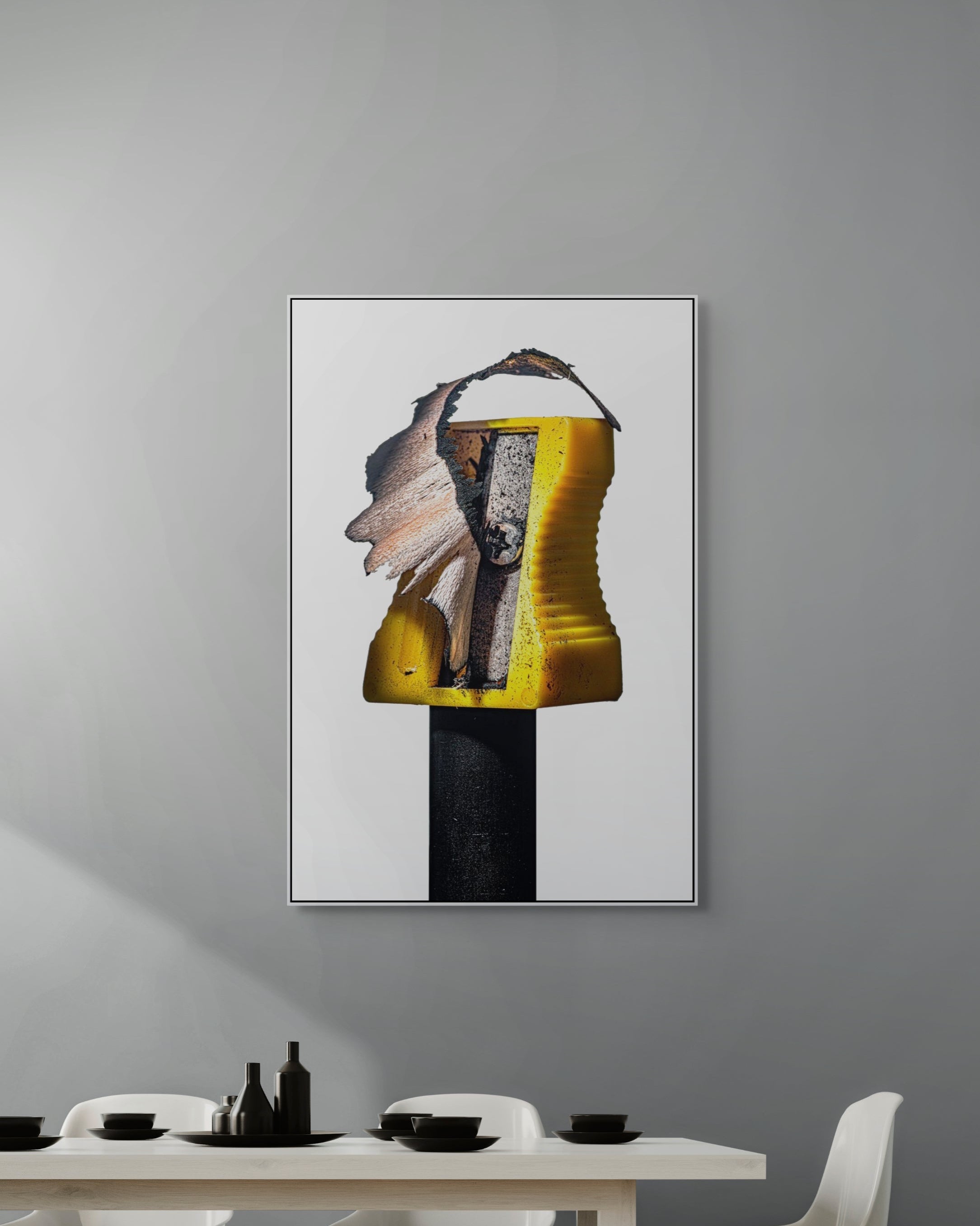 Abstract art piece on a gray wall above a dining table.