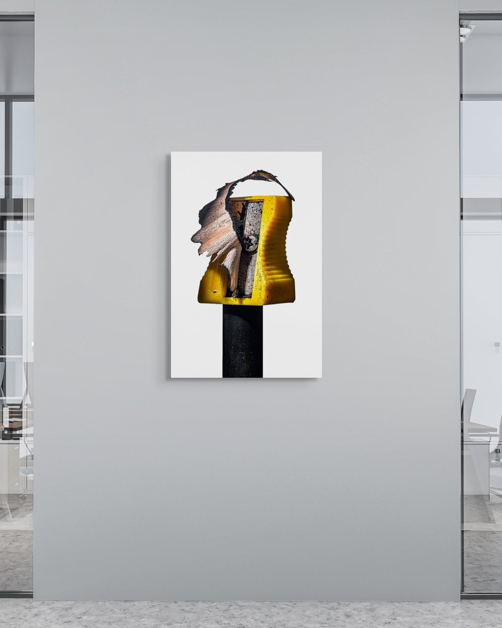 Modern office interior with a metal print of a pencil sharpener on a wall.