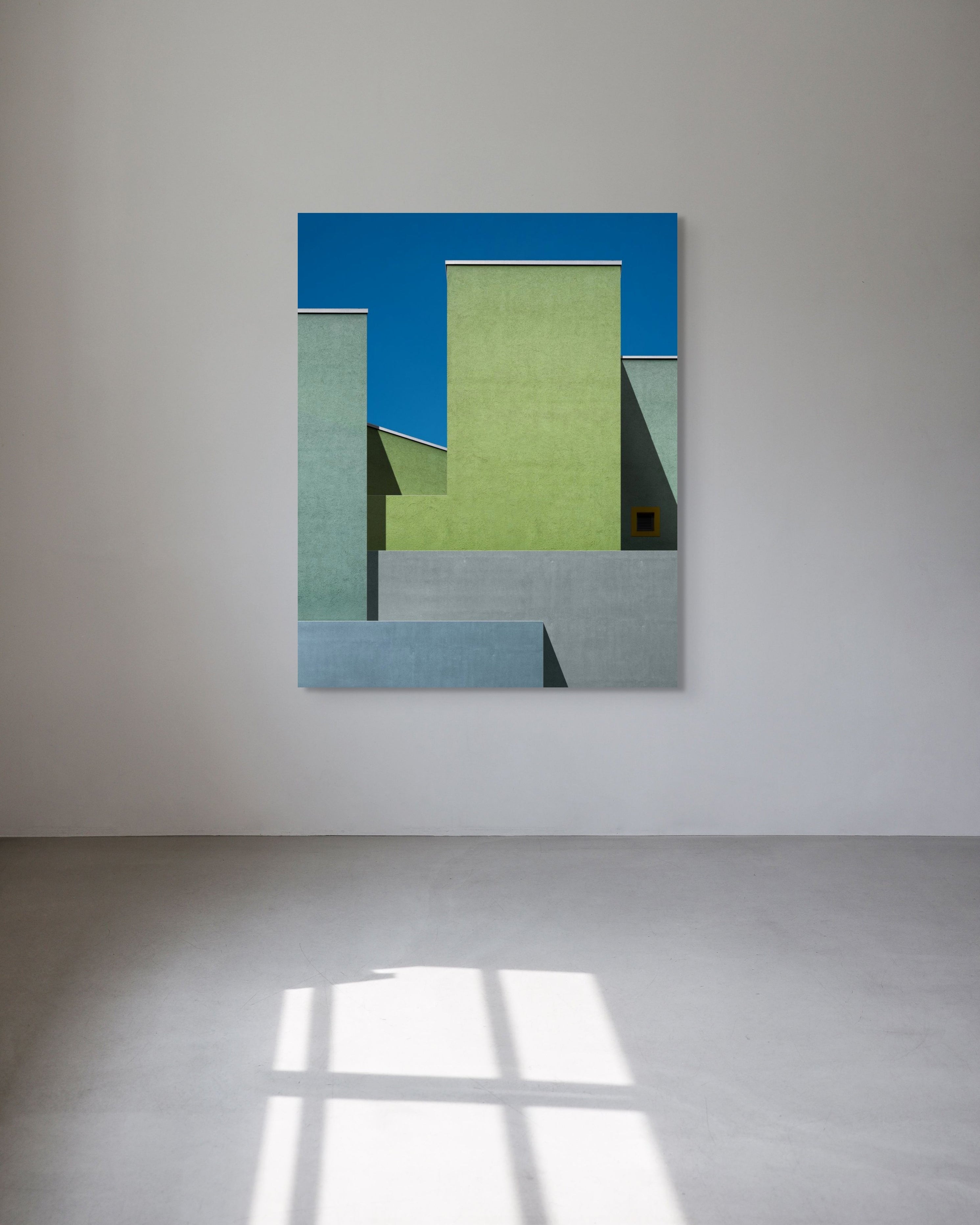 Architectural metal print with a blue sky background on a wall.