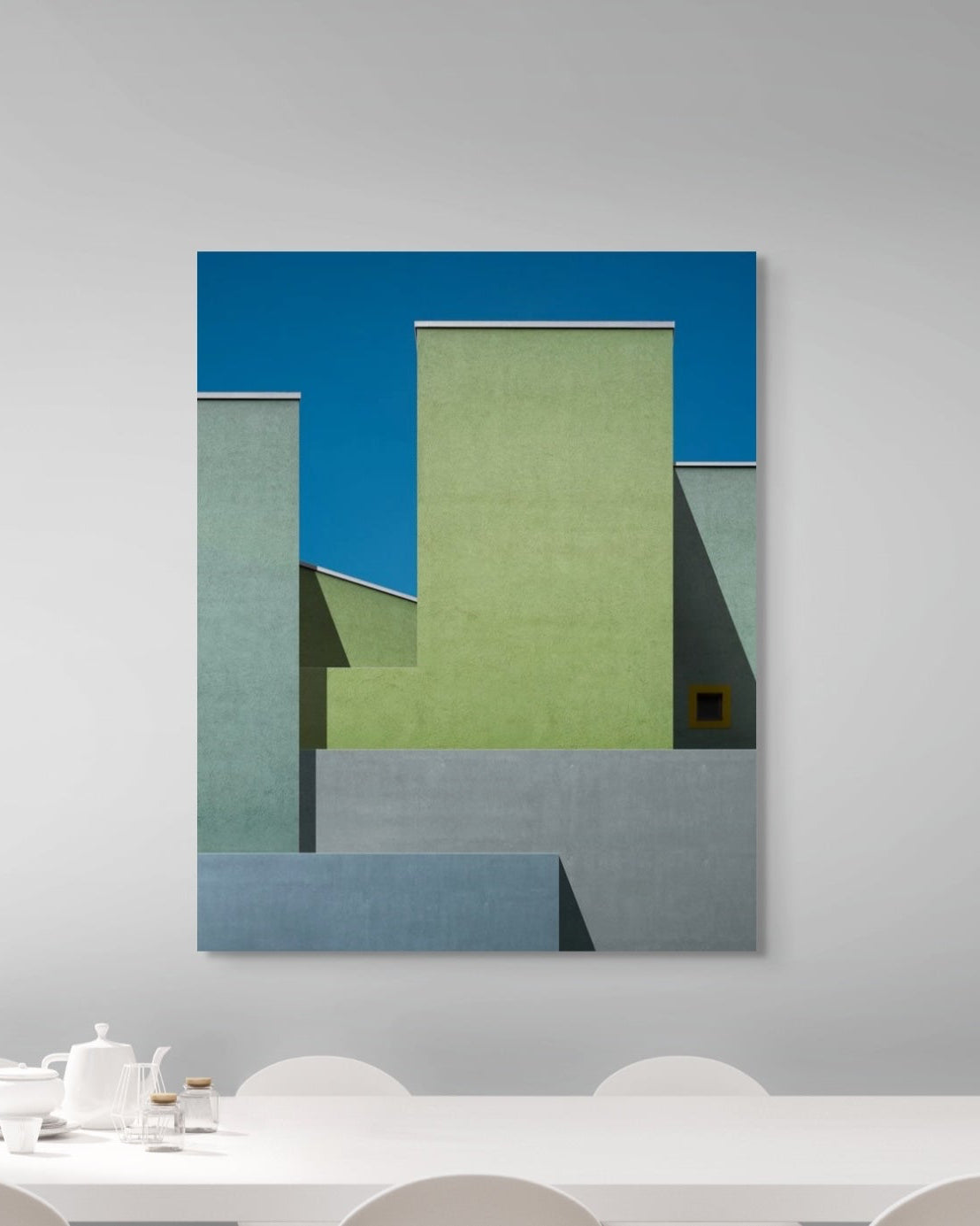 Abstract art print on a wall above a dining table
