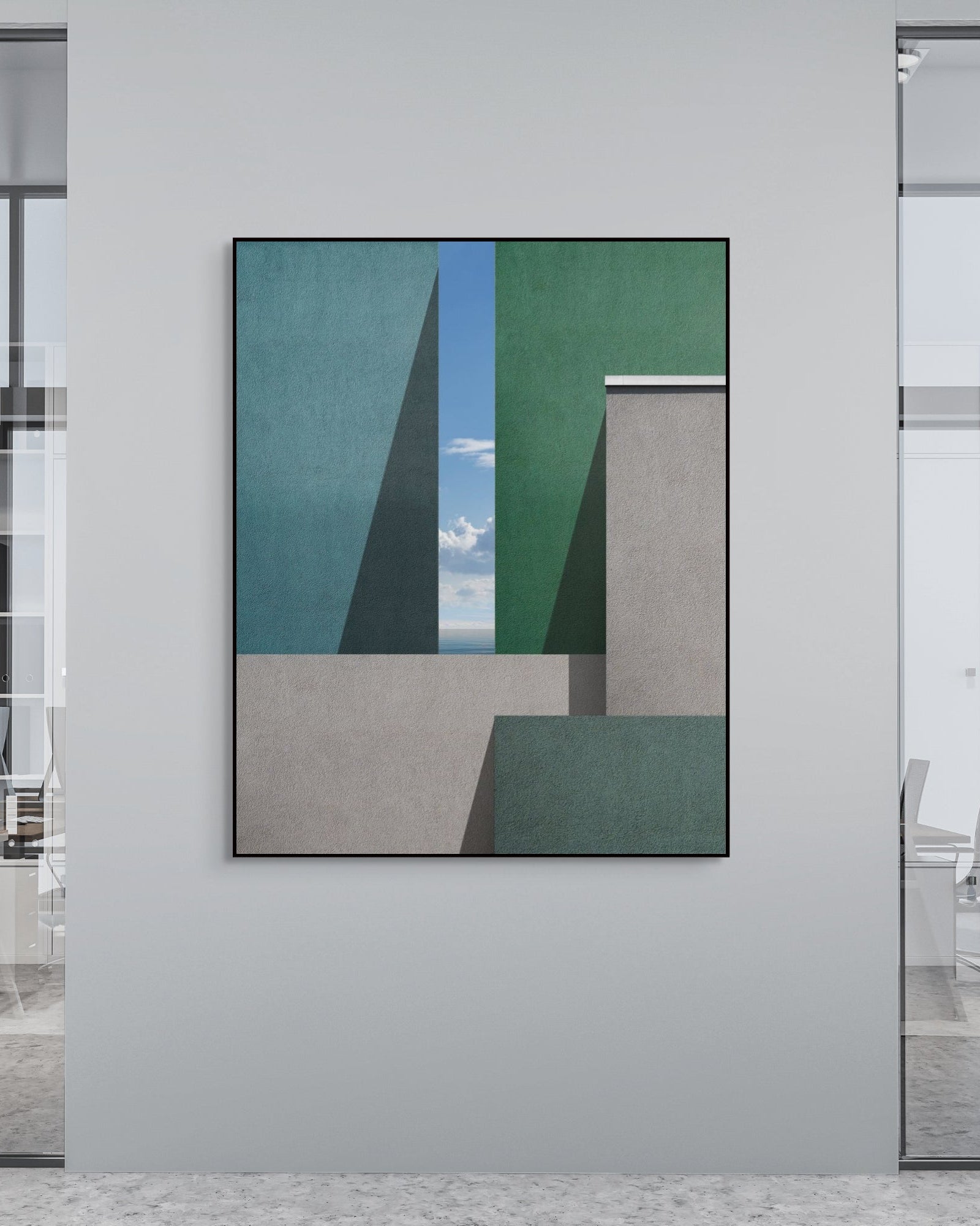 Modern office interior with an architectural print on a wall.