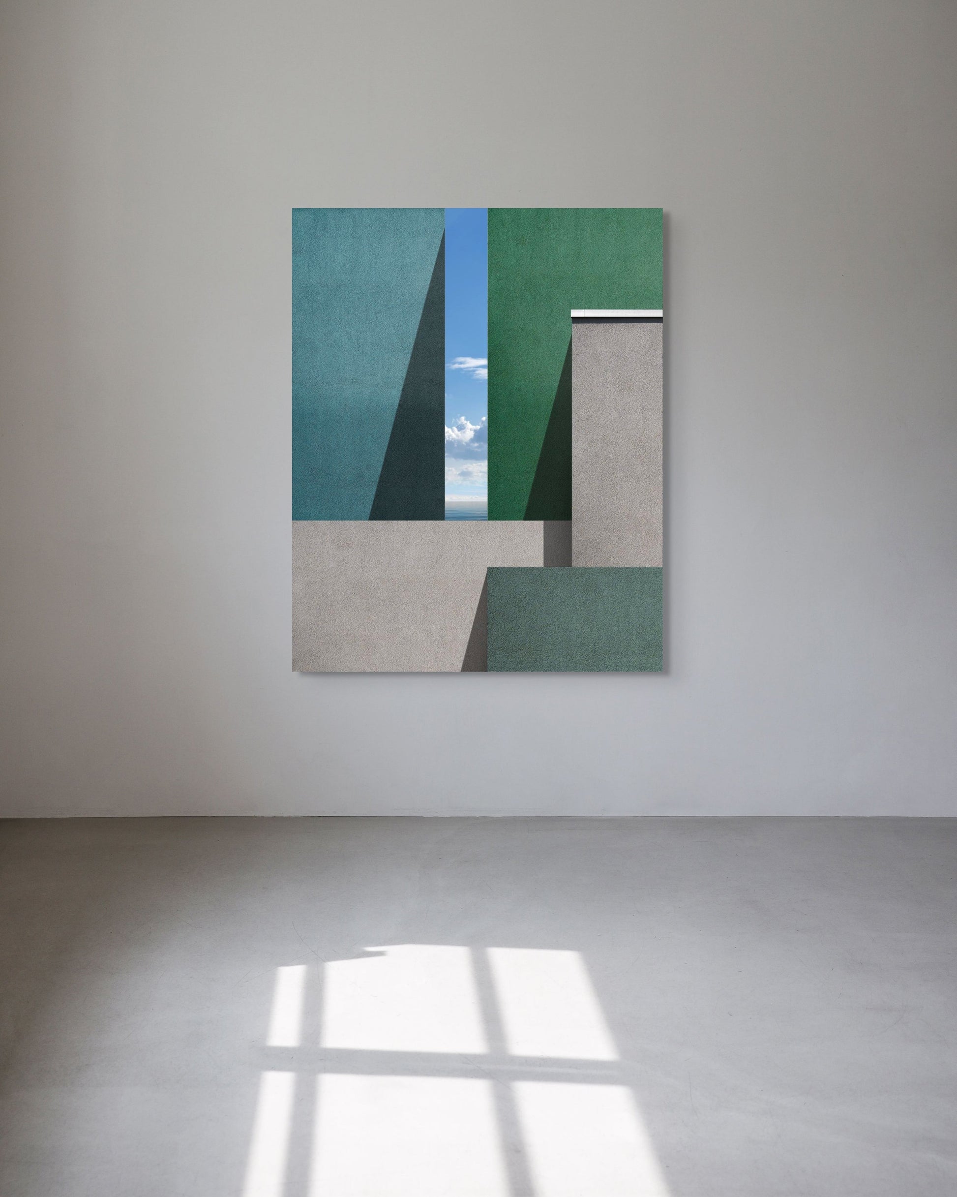 Metal print on a white wall with geometric shapes