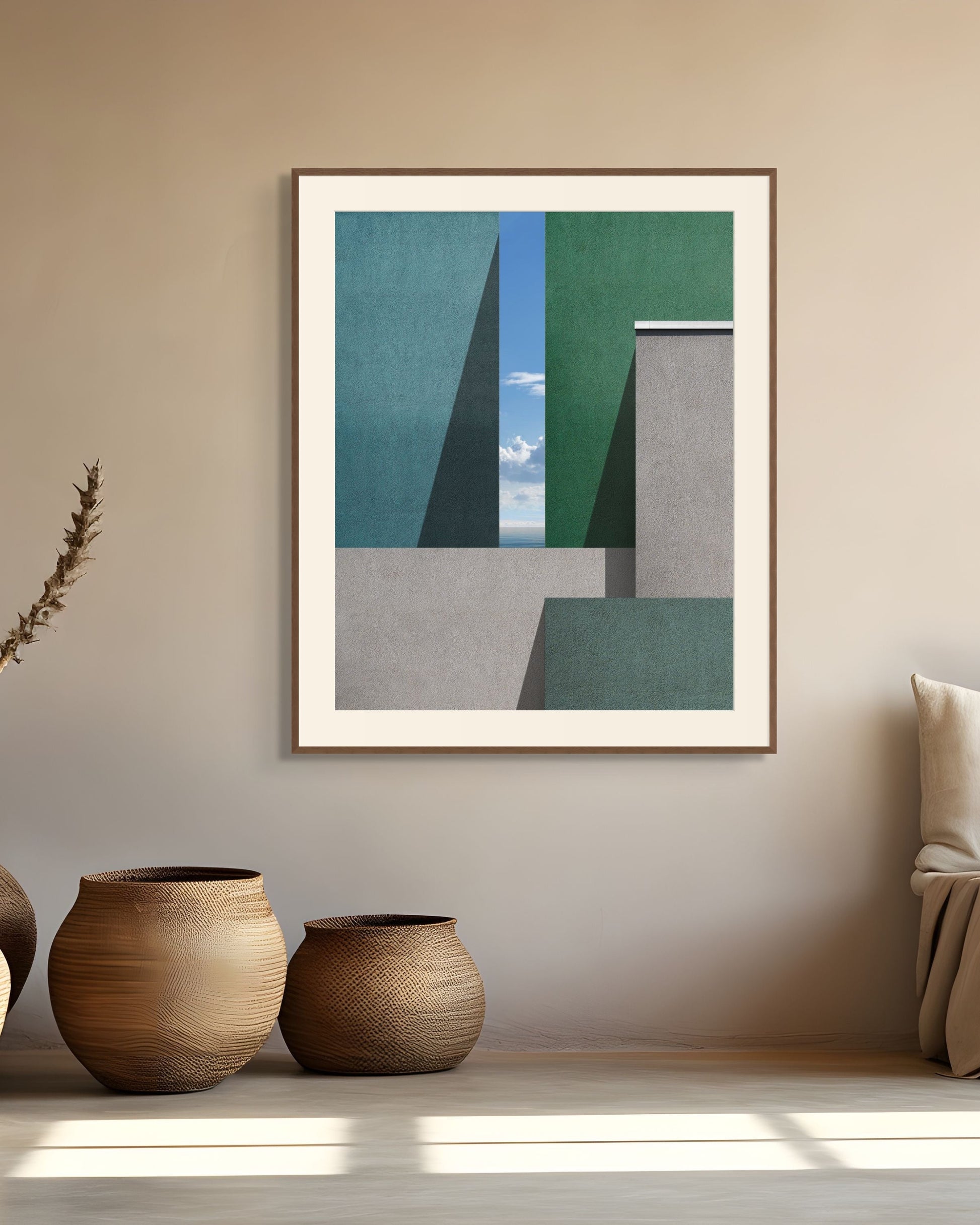 Framed architectural print on a wall with decorative vases and a sofa in a room.