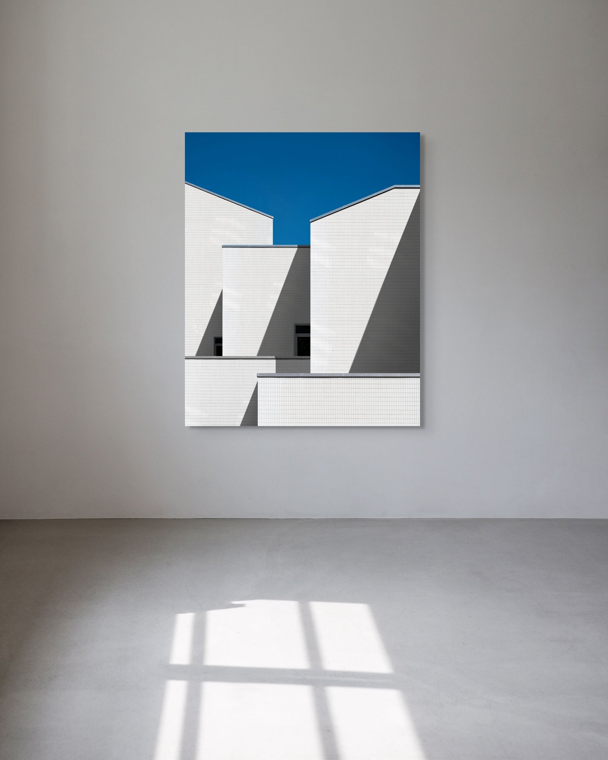 Abstract art piece with geometric shapes on a white wall