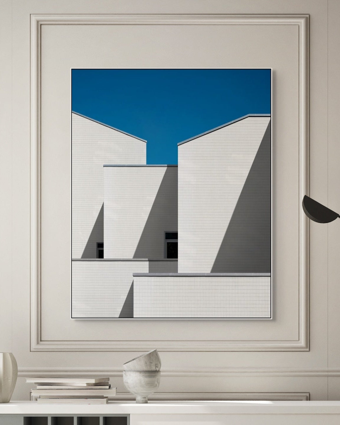 Abstract art print in a modern interior setting with a lamp and decor items.