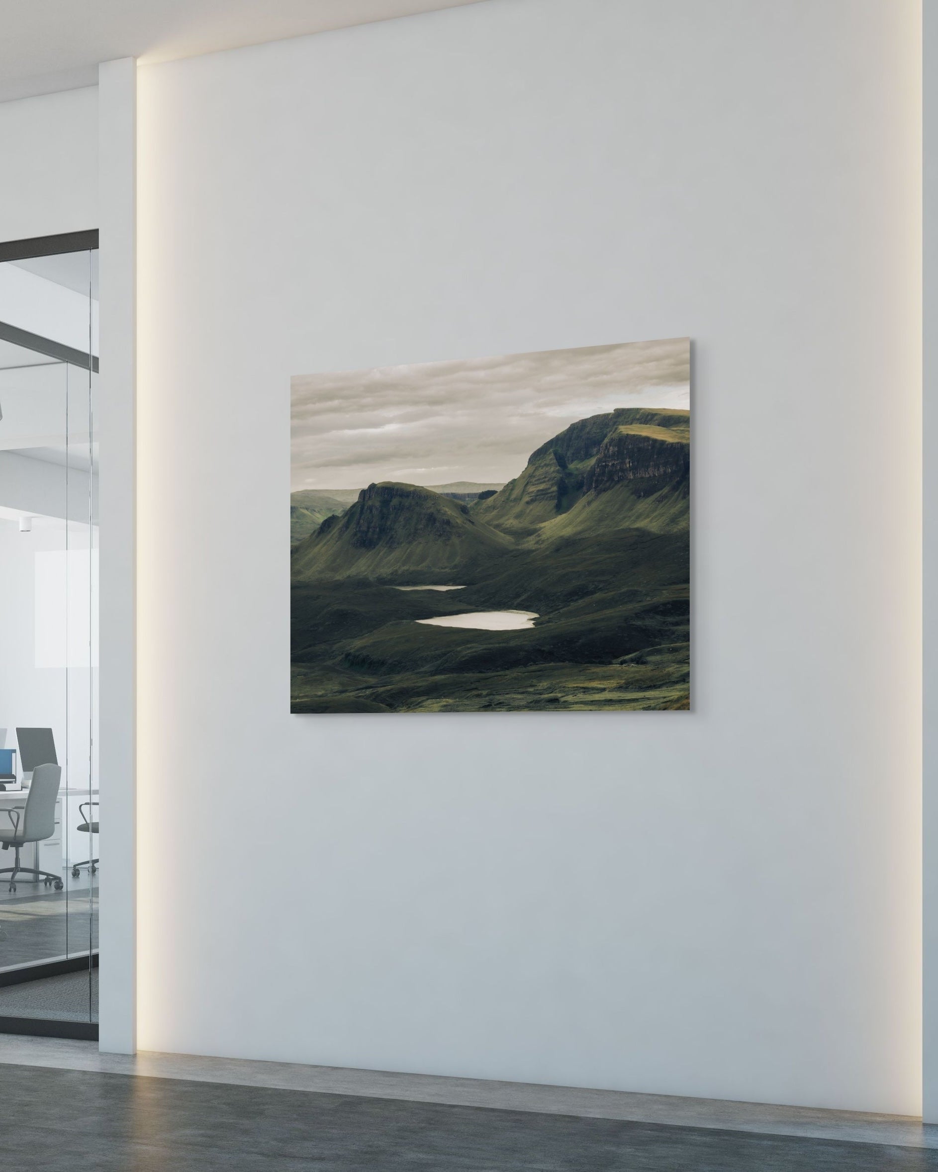 Artistic depiction of a mountain landscape on a wall in an office setting
