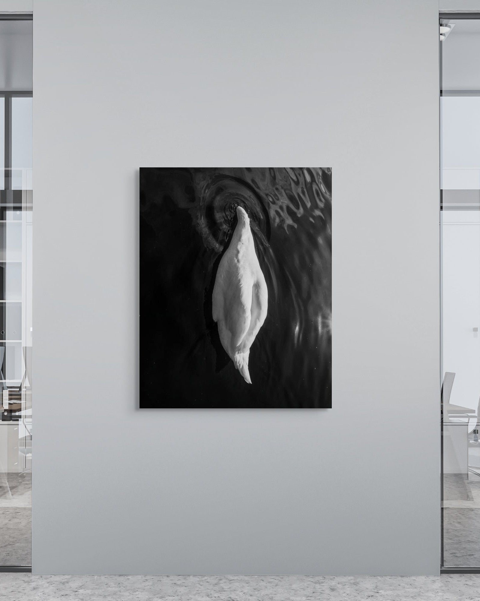 Modern office interior with a black and white abstract print on a wall.