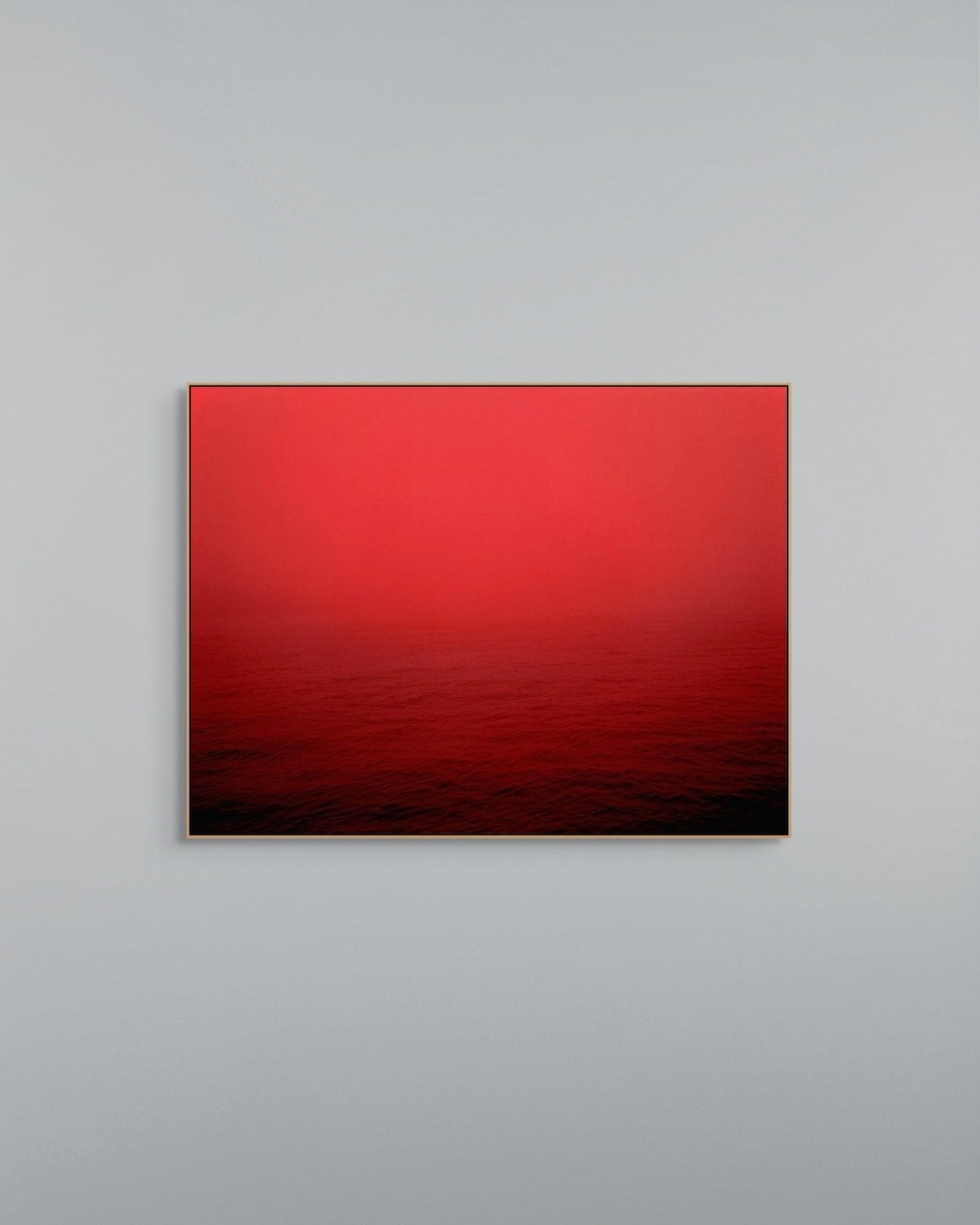 Red abstract metal print on a gray wall