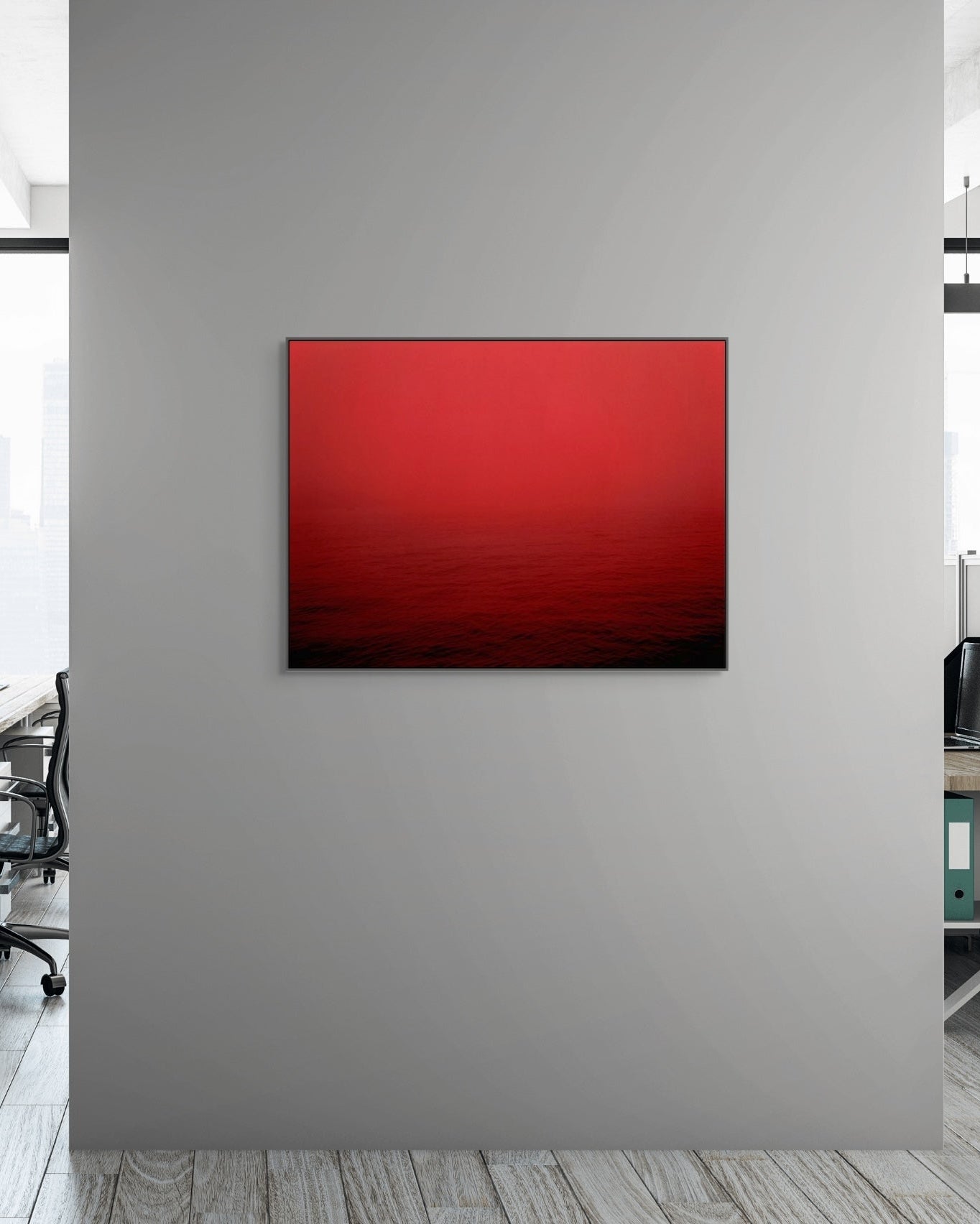 Red abstract print on a gray wall in an office setting