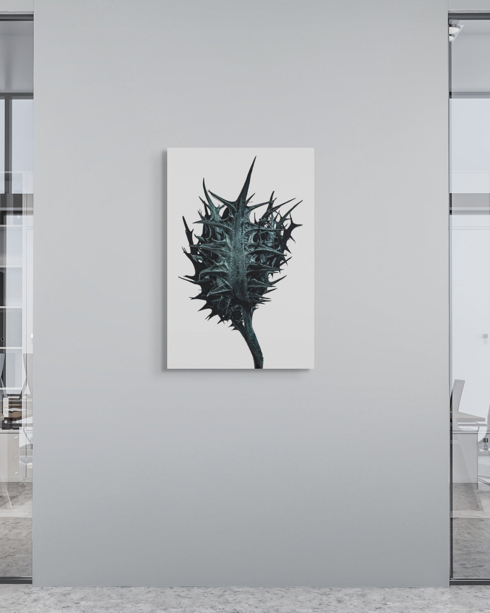 Modern office interior with a unique plant-like artwork on a gray wall.