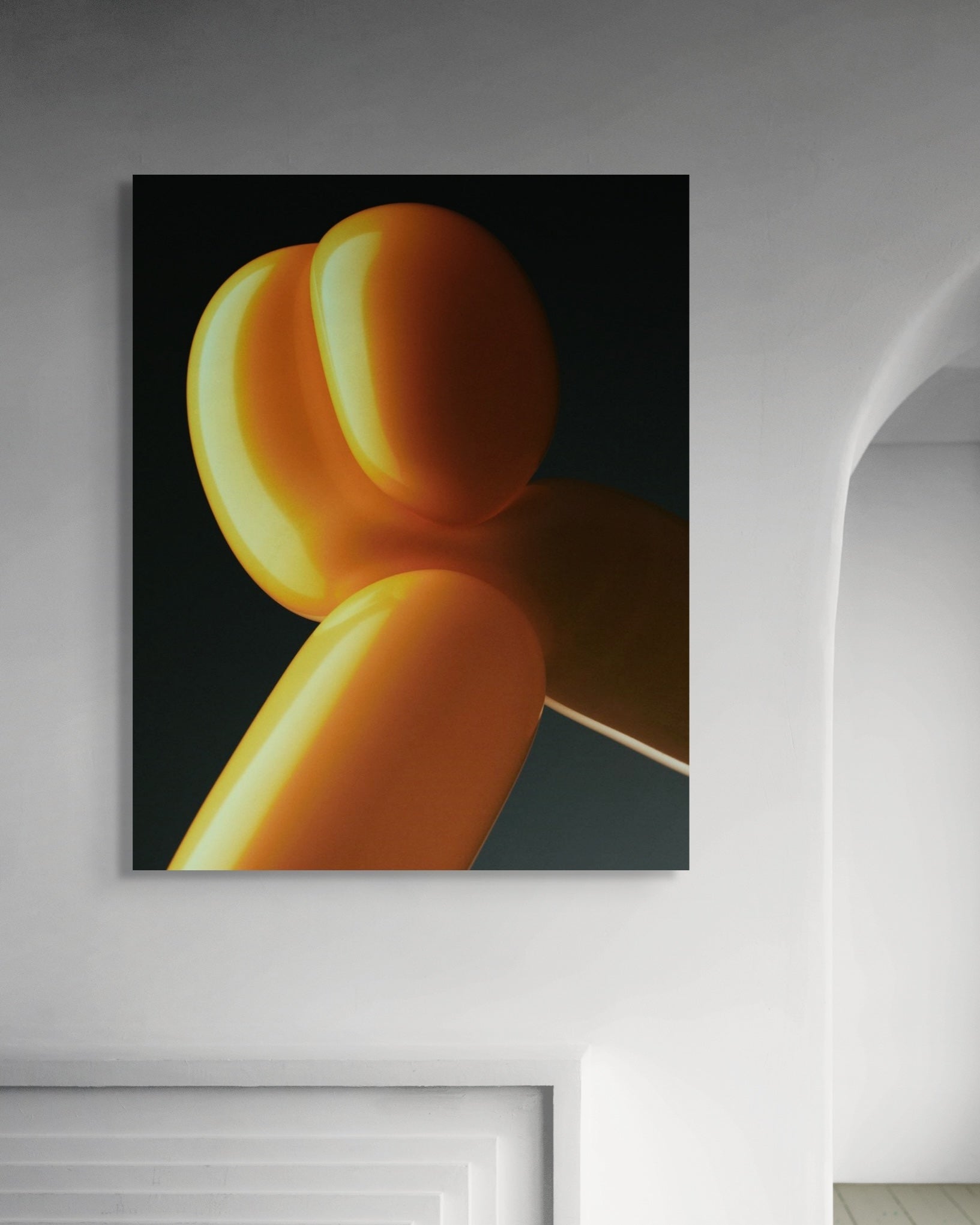 Abstract art piece of orange balloons on a dark background in a modern room.