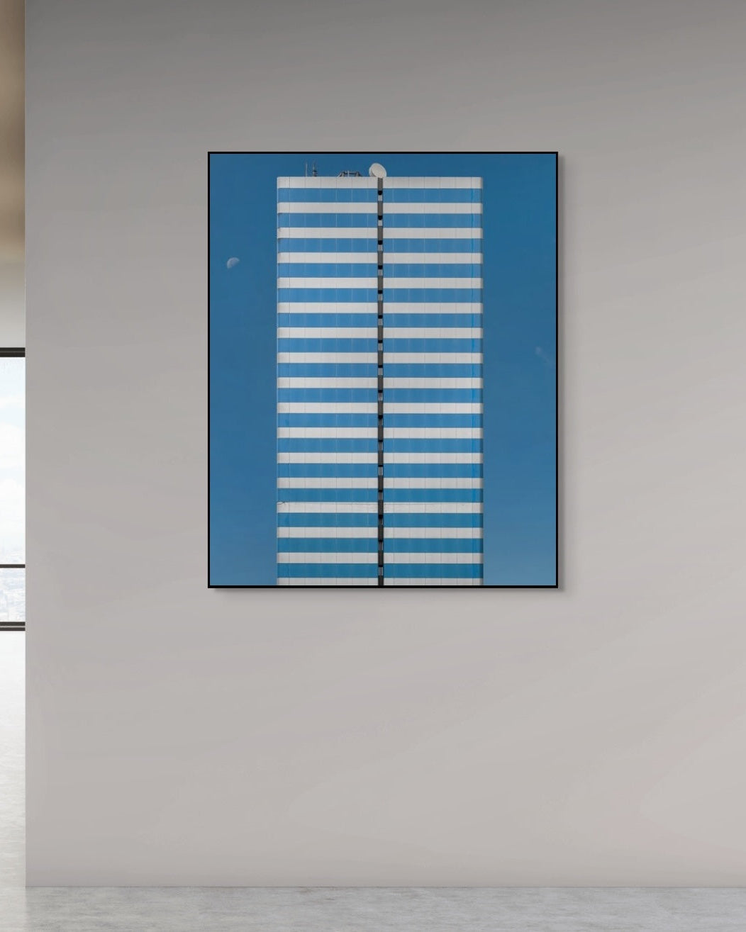 Abstract art piece with blue and white stripes on a gray wall